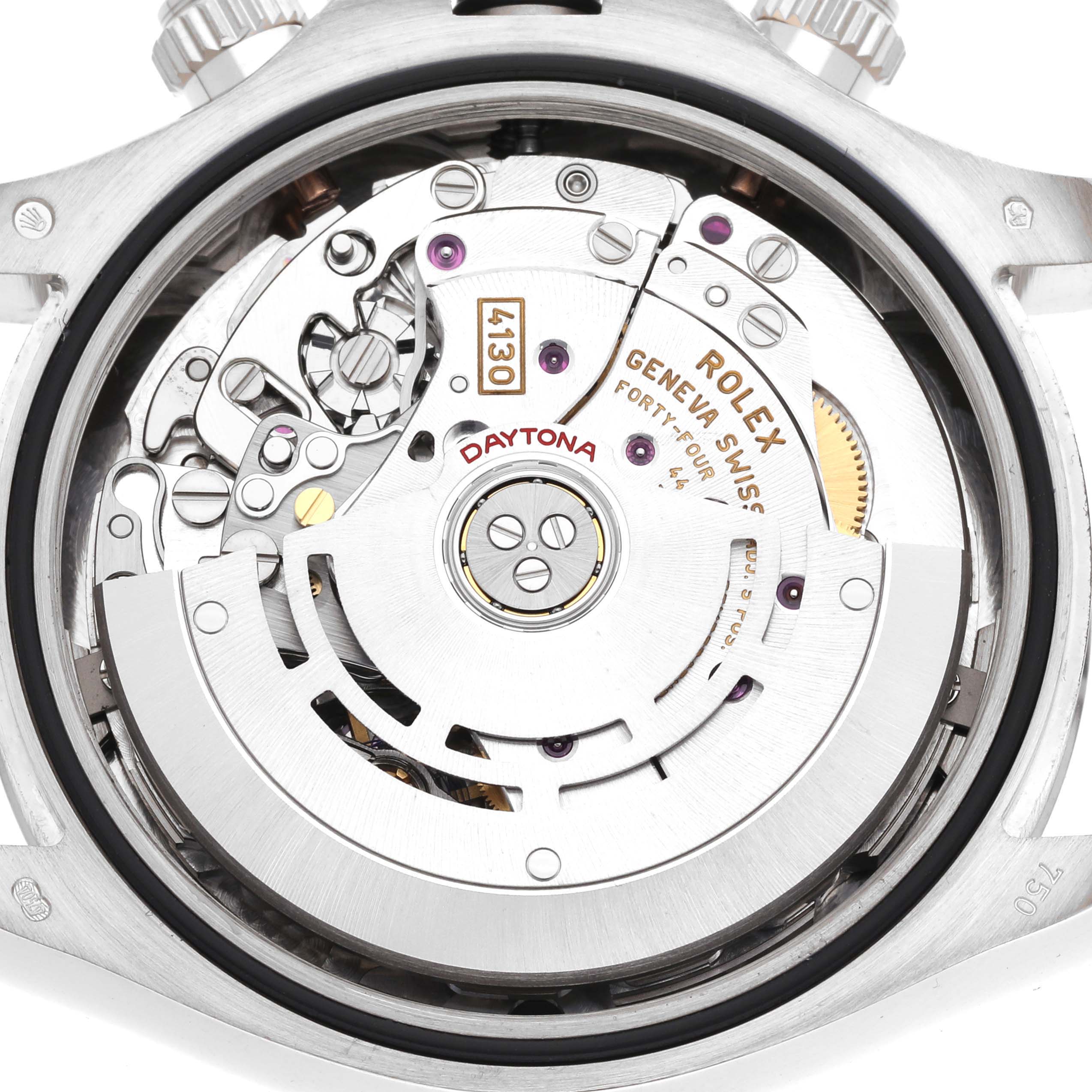 The image shows the movement of a Rolex Daytona 116509 Men's White Gold Grey Dial watch from a close-up angle, displaying the gears and inner mechanisms.