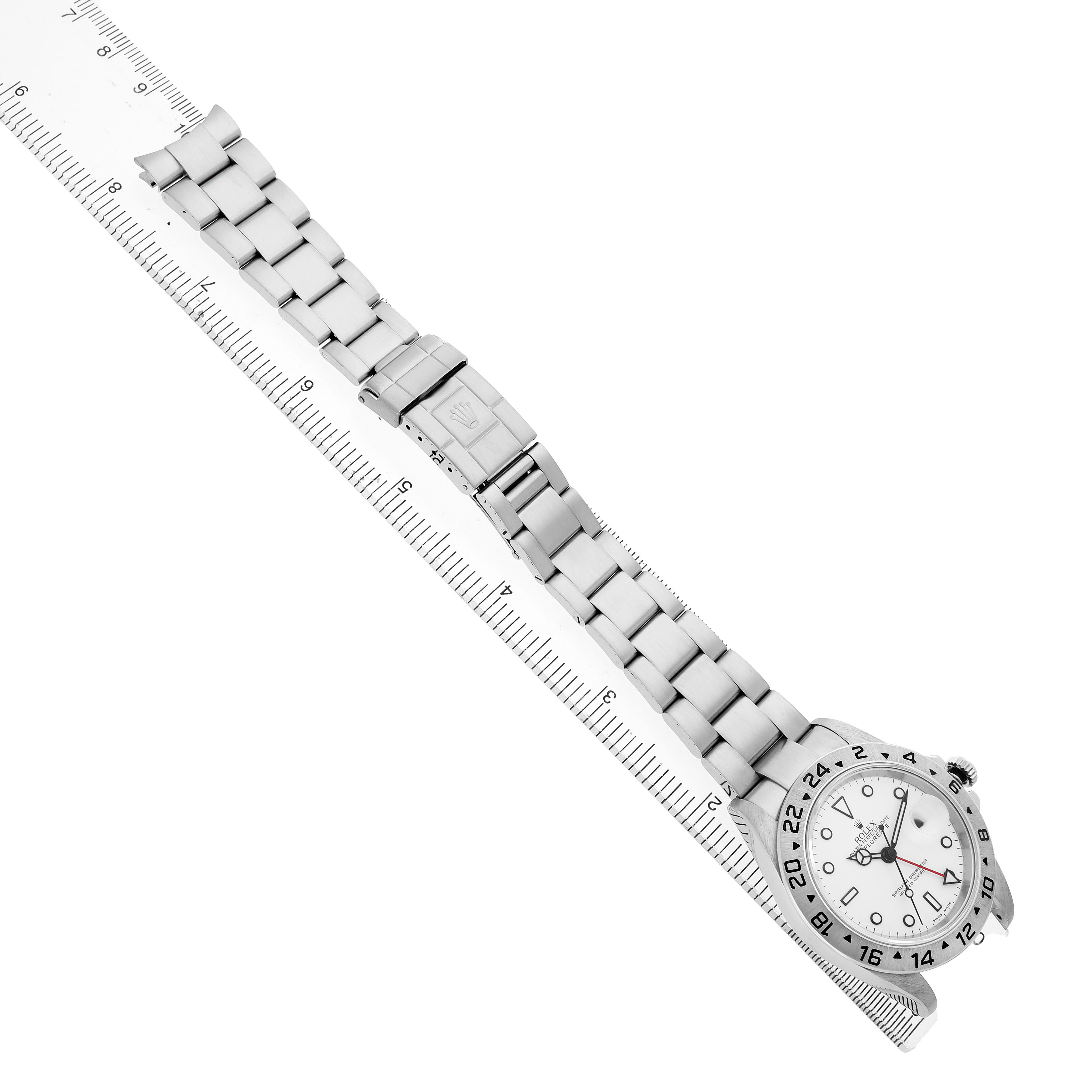 The Rolex Explorer 16570 Men's Stainless Steel White Dial is shown at an angled top view, highlighting the bracelet, clasp, and face, with a ruler for reference.