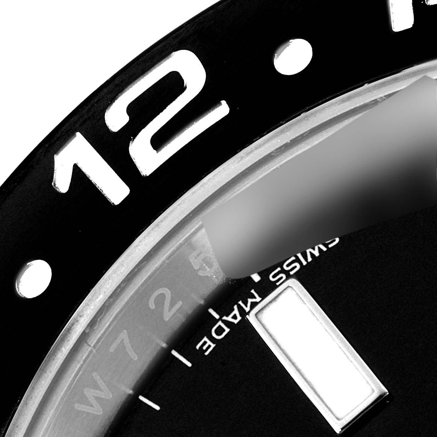 The image shows a close-up of the bezel and part of the dial of a Rolex GMT-Master 116710 Men's Stainless Steel Black Dial 116710 Men's Stainless Steel Black Dial watch, including the "12" marker and "Swiss Made" text.
