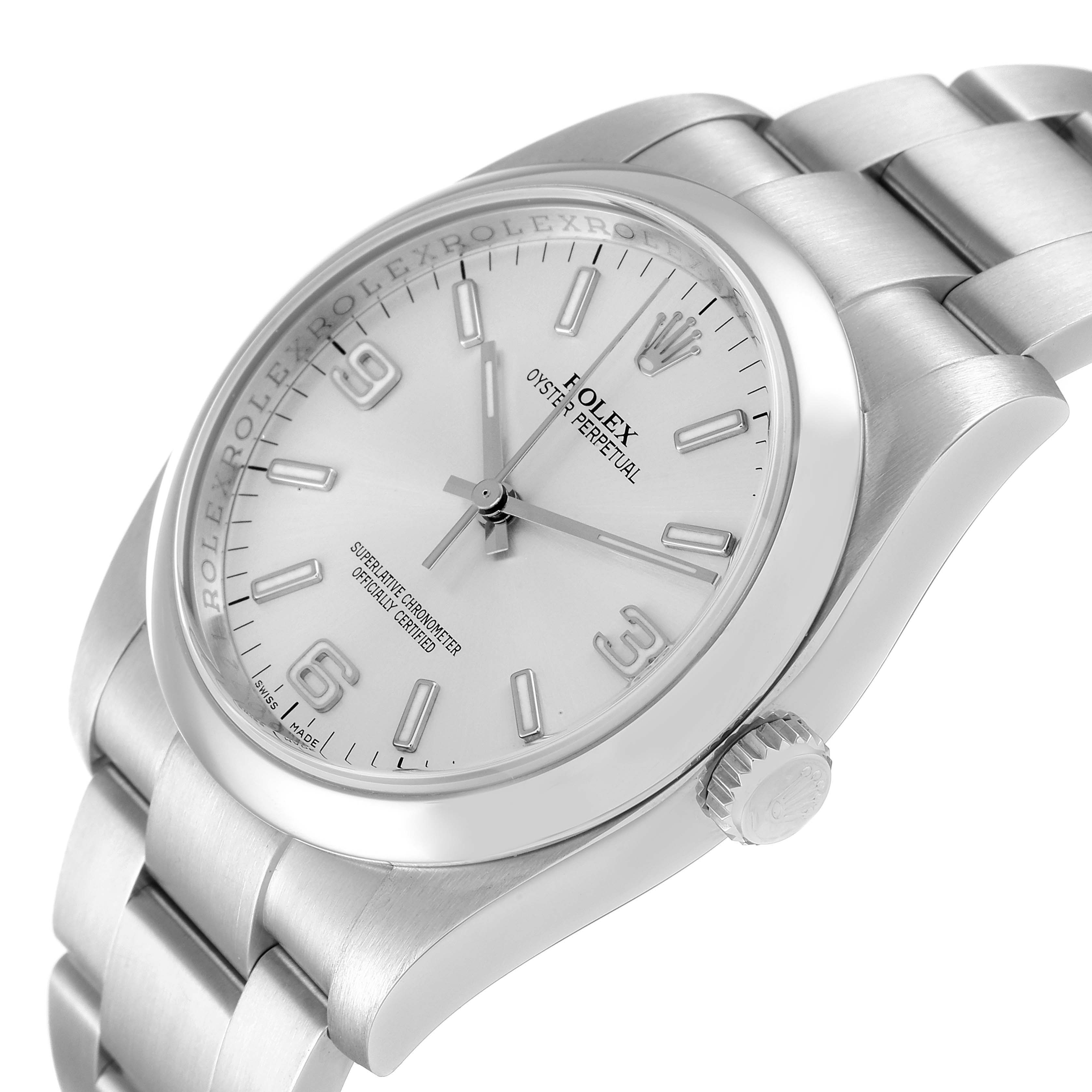 The Rolex Oyster Perpetual 116000 Men's Stainless Steel Silver Dial 116000 Men's Stainless Steel Silver Dial watch is shown at an angle showcasing its face, bezel, crown, and part of the bracelet.