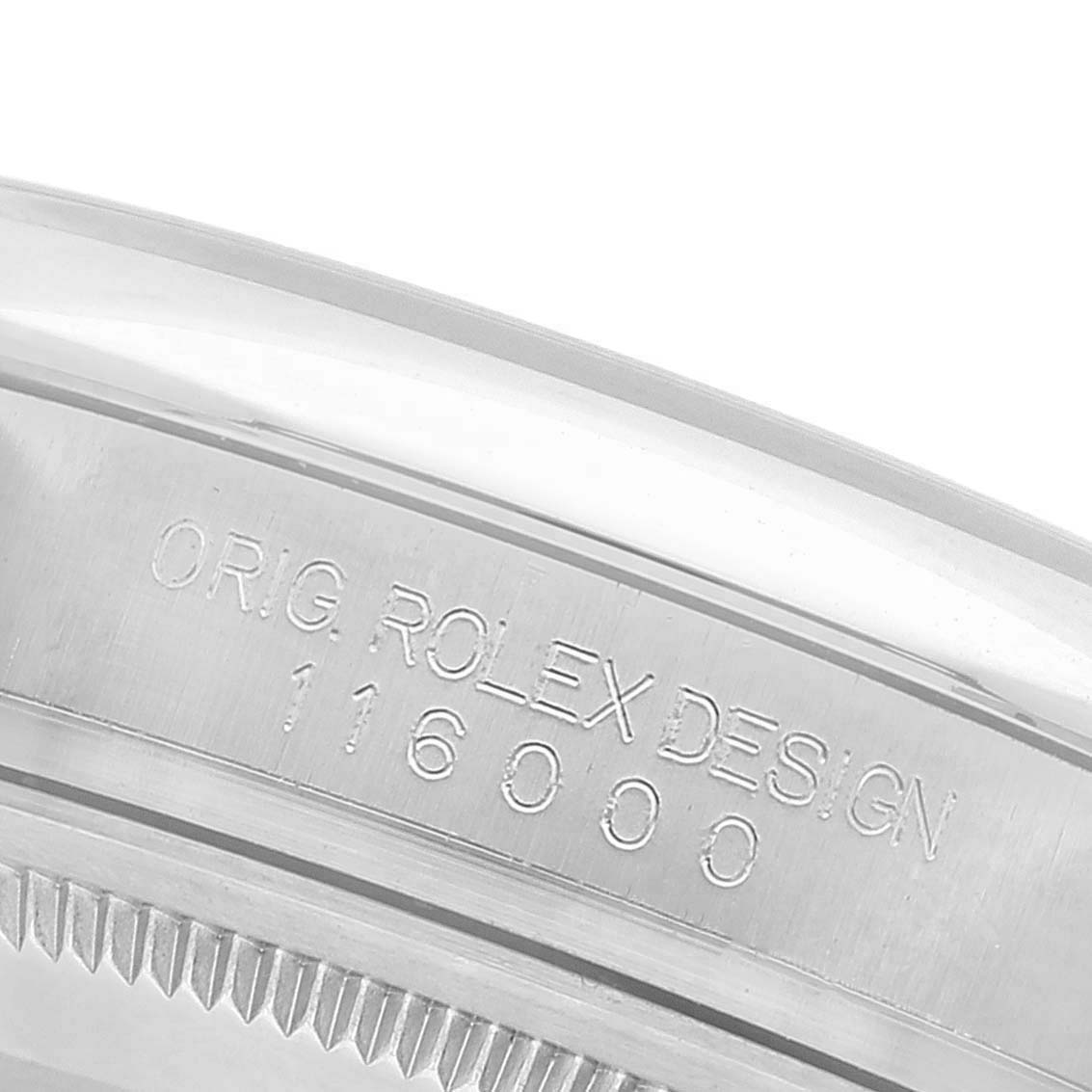 The image shows a close-up of the case side and bezel of the Rolex Oyster Perpetual 116000 Men's Stainless Steel Silver Dial 116000 Men's Stainless Steel Silver Dial, displaying its model number and "ORIG. ROLEX DESIGN" engraving.