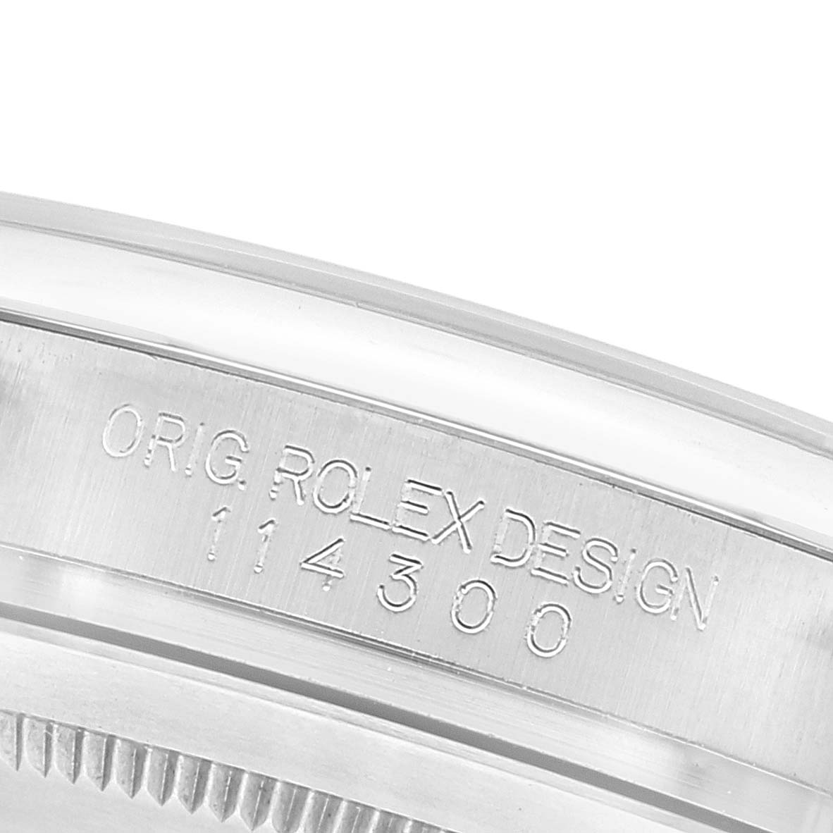 This image shows the engraved side of the case back of a Rolex Oyster Perpetual 114300 Men's Stainless Steel Grey Dial 114300 Men's Stainless Steel Grey Dial watch.