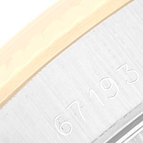 This close-up image shows the edge of the case with Rolex Oyster Perpetual 67193 Women's Steel and Gold (two tone) Champagne Dial 67193 Women's Steel and Gold (two tone) Champagne Dial markings and partial serial number "67193."