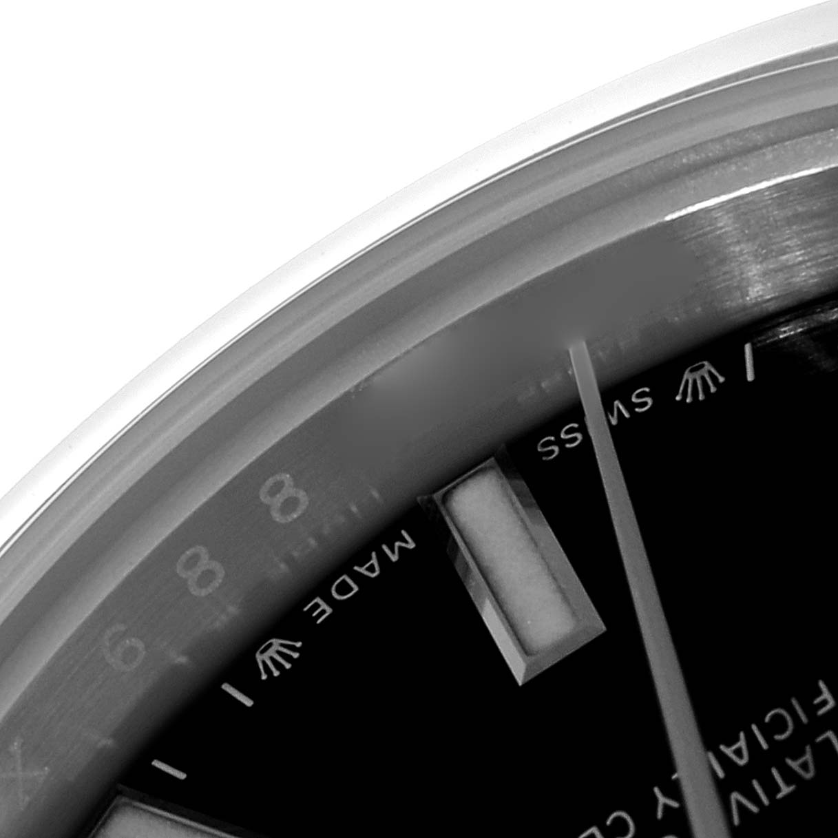 The image shows a close-up angled view of the dial details of a Rolex Oyster Perpetual 276200 Women's Stainless Steel Black Dial 276200 Women's Stainless Steel Black Dial watch, highlighting parts of the hour markers and text.