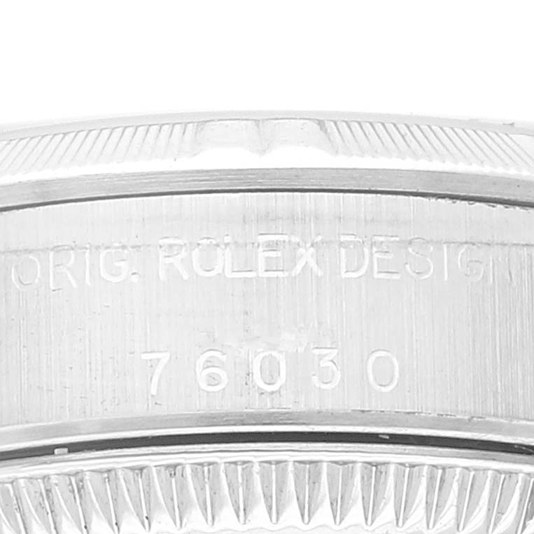 This image shows the side engraving and bezel of a Rolex Oyster Perpetual 76030 Women
s Stainless Steel Pink Dial 76030 Women
s Stainless Steel Pink Dial watch, featuring the model number and design inscription.
