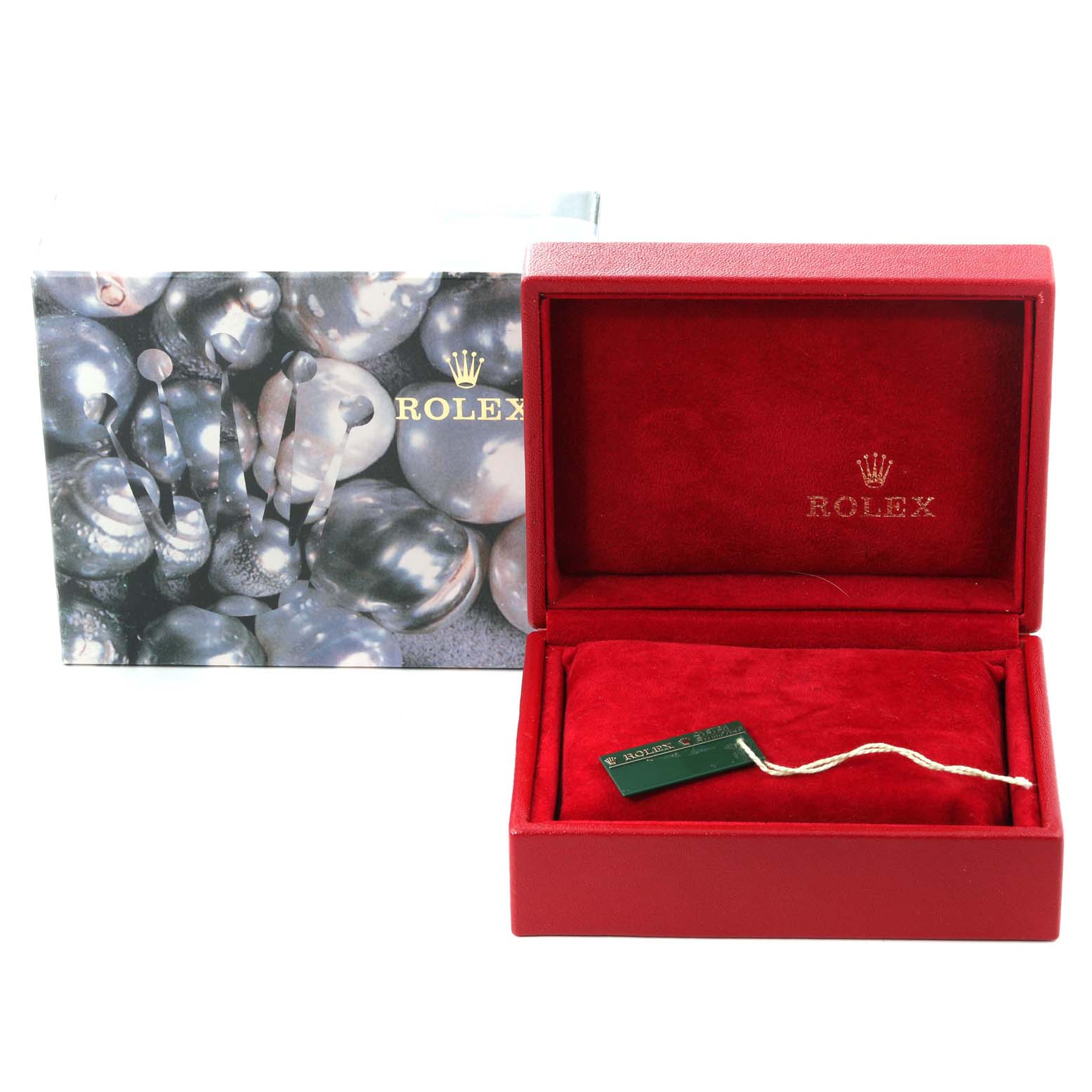 The image shows an open red Rolex box for the Oyster Perpetual model with a hangtag, along with the outer packaging.
