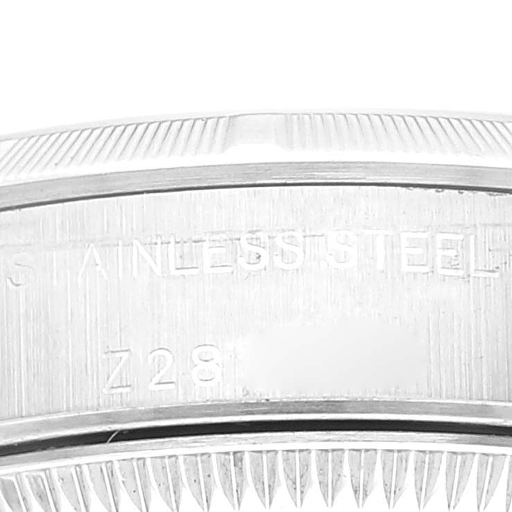 This image shows a close-up of the stainless steel case back of the Rolex Oyster Perpetual 76030 Women
s Stainless Steel Pink Dial 76030 Women
s Stainless Steel Pink Dial watch.