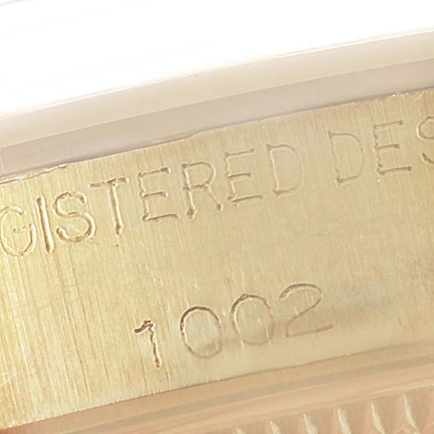 The image shows a close-up of the engraved case side of the Rolex Vintage Collection 1002 Men's Yellow Gold Grey Dial 1002 Men's Yellow Gold Grey Dial model watch.