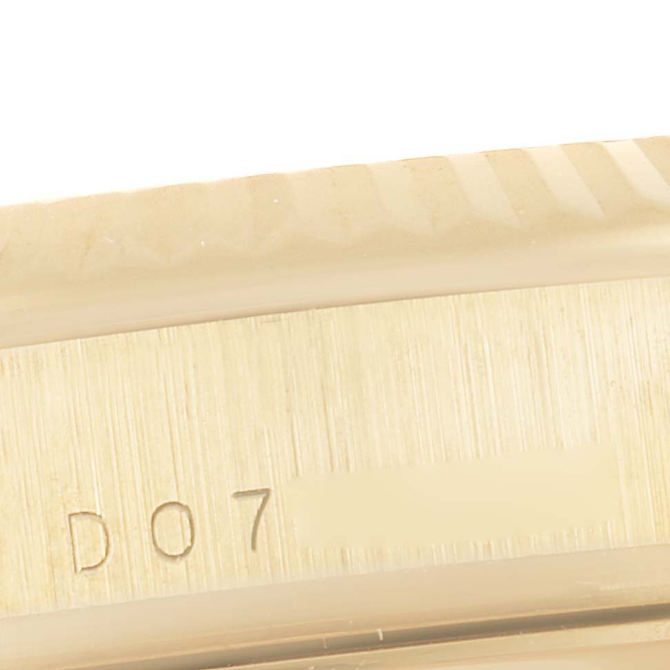 This close-up image shows the edge and part of the serial number engraving on the Rolex President 118238 Men
s Yellow Gold Black Dial 118238 Men
s Yellow Gold Black Dial model watch.