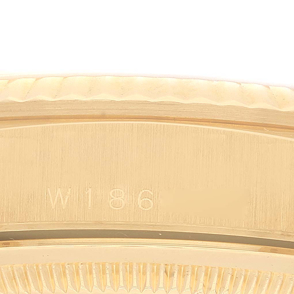 This close-up image shows the side of the case and the serial number on the bezel of a Rolex President 18238 Men
s Yellow Gold Champagne Dial 18238 Men
s Yellow Gold Champagne Dial model watch.