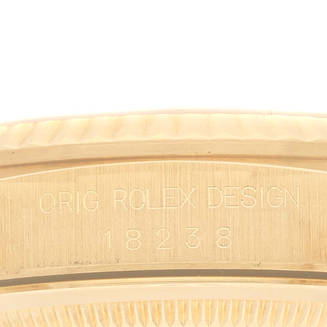 The image shows an angled close-up of the side of the Rolex President 18238 Men
s Yellow Gold Champagne Dial 18238 Men
s Yellow Gold Champagne Dial model watch, highlighting its design engraving.