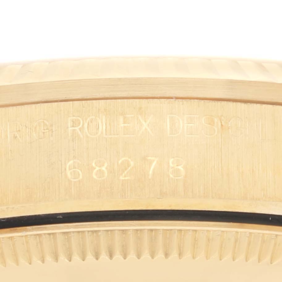 The image shows a close-up of the side of a Rolex President 68278 Women
s Yellow Gold Champagne Dial 68278 Women
s Yellow Gold Champagne Dial model watch, highlighting the serial number and design engraving.
