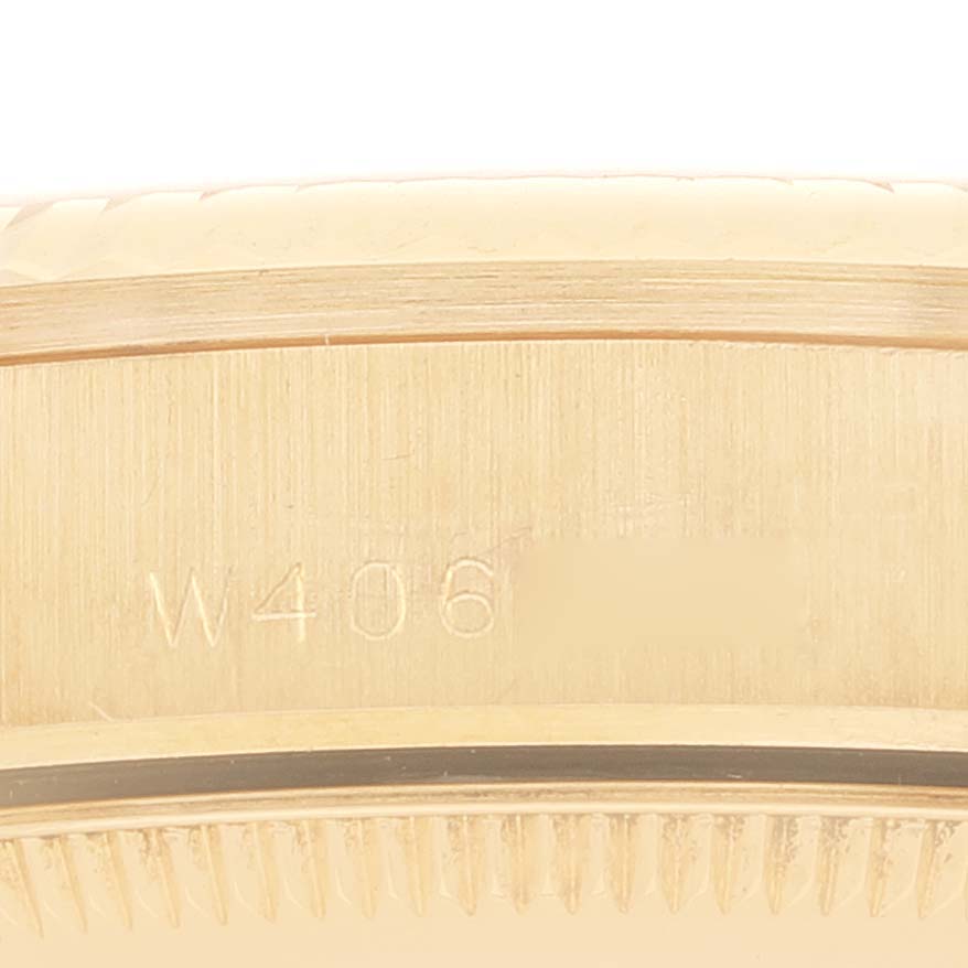 This image shows a close-up of the side of a Rolex President 68278 Women
s Yellow Gold Champagne Dial 68278 Women
s Yellow Gold Champagne Dial model watch, focusing on the band and serial number engraving.