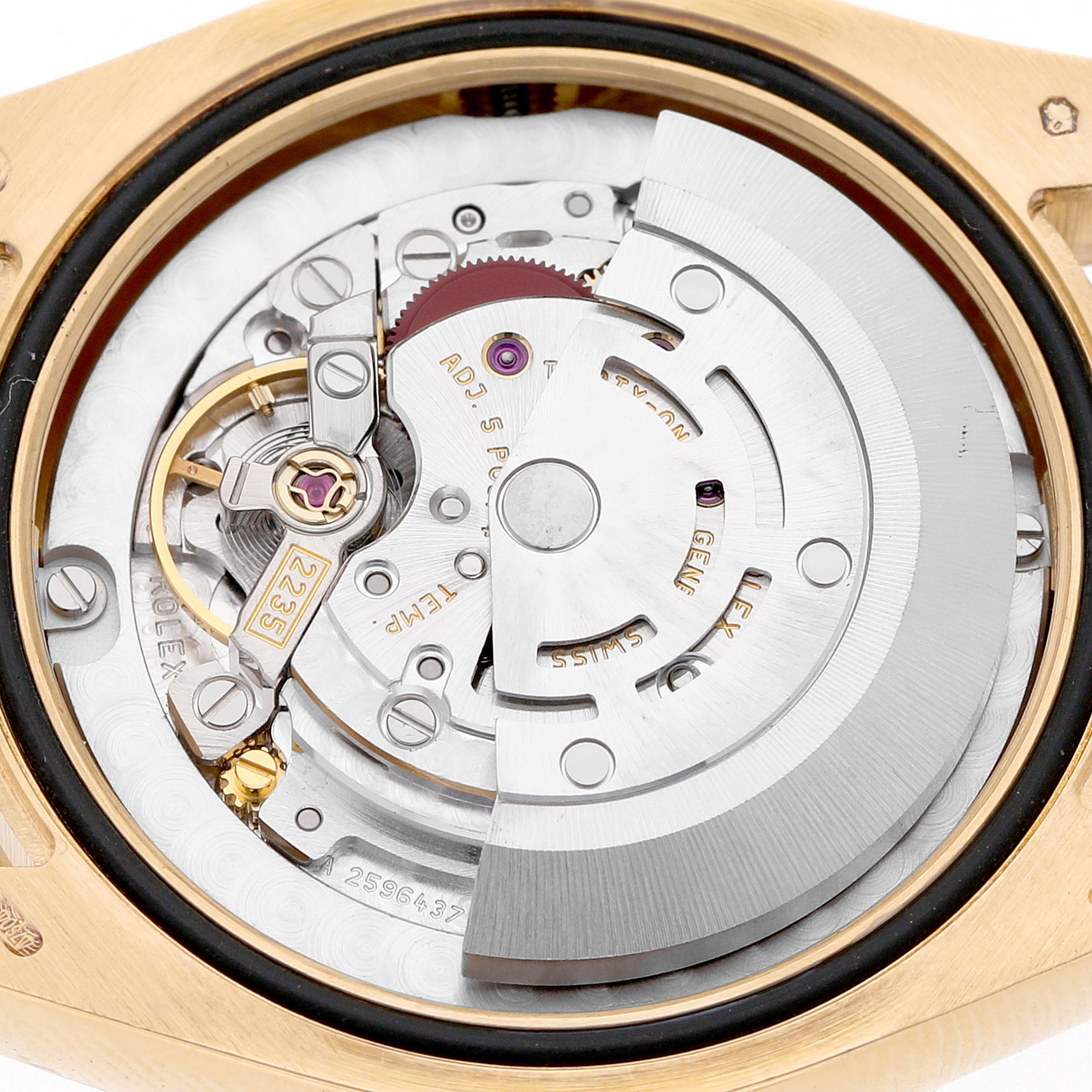 This image shows the movement of a Rolex President 178288 Women's Yellow Gold Mother of Pearl Dial model watch from the back, highlighting the intricate rotor and balance wheel.