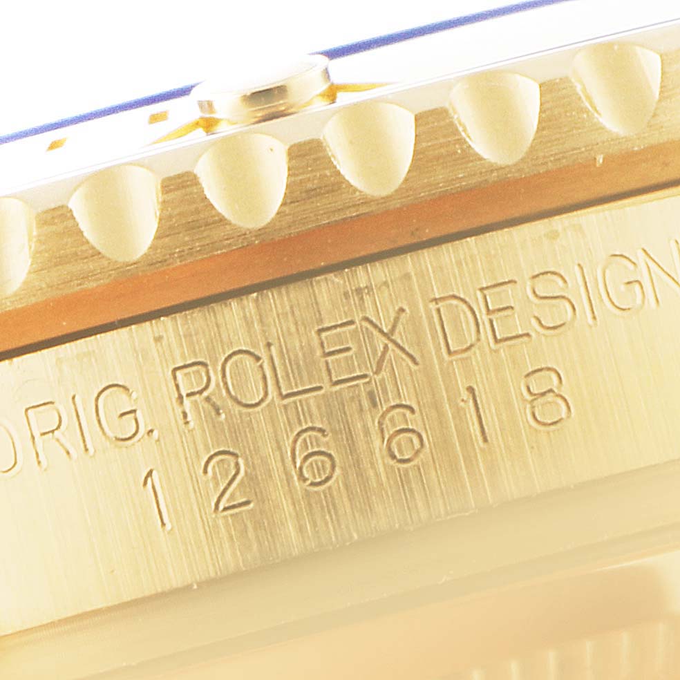 This image shows the side angle of the bezel and engraved case of the Rolex Submariner 126618 Men's Yellow Gold Black Dial 126618 Men's Yellow Gold Black Dial watch, featuring the model number 126618.