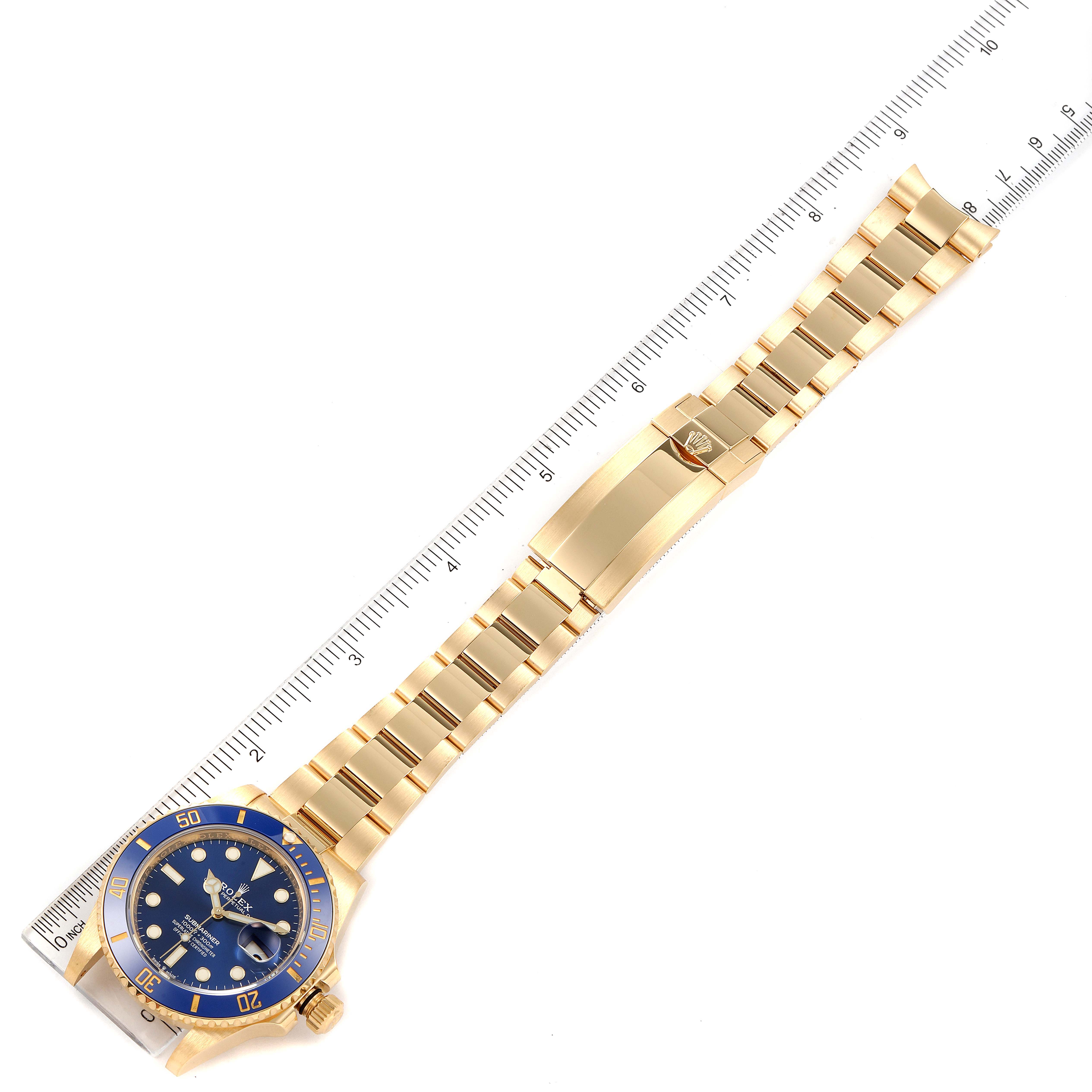 The image shows a Rolex Submariner 126618 Men's Yellow Gold Black Dial 126618 Men's Yellow Gold Black Dial watch with a gold bracelet and a blue dial, laid flat next to a ruler for size reference.