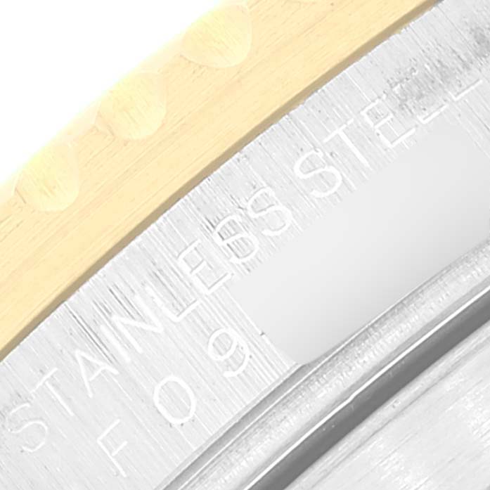 The image shows a close-up of the outer stainless steel and gold bezel of a Rolex Submariner 16613 Men
s Steel and Gold (two tone) Blue Dial 16613 Men
s Steel and Gold (two tone) Blue Dial watch.