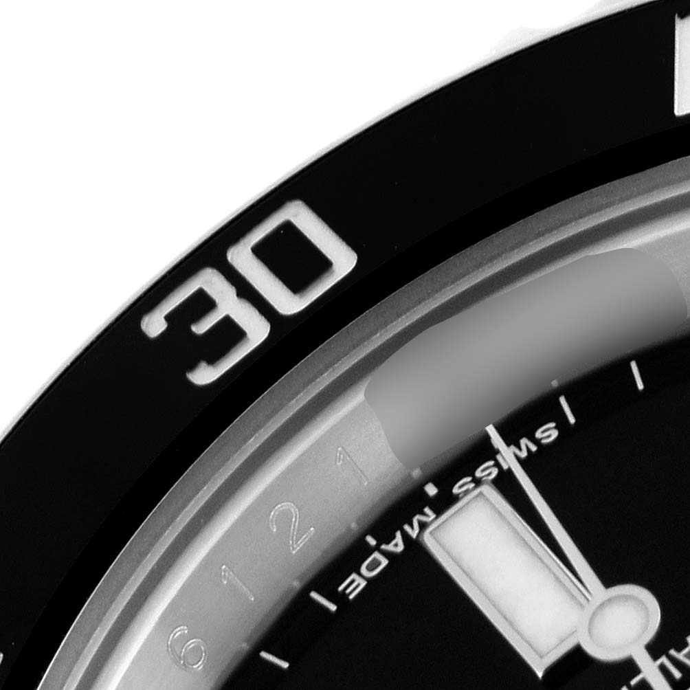 Close-up of the bezel and part of the dial of a Rolex Submariner 116610 Men
s Stainless Steel Black Dial 116610 Men
s Stainless Steel Black Dial, showing the 30-minute marker and some hour markings.