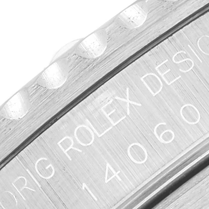 This close-up image shows the engraved side of the bezel and case of a Rolex Submariner 14060 Men
s Stainless Steel Black Dial 14060 Men
s Stainless Steel Black Dial model.