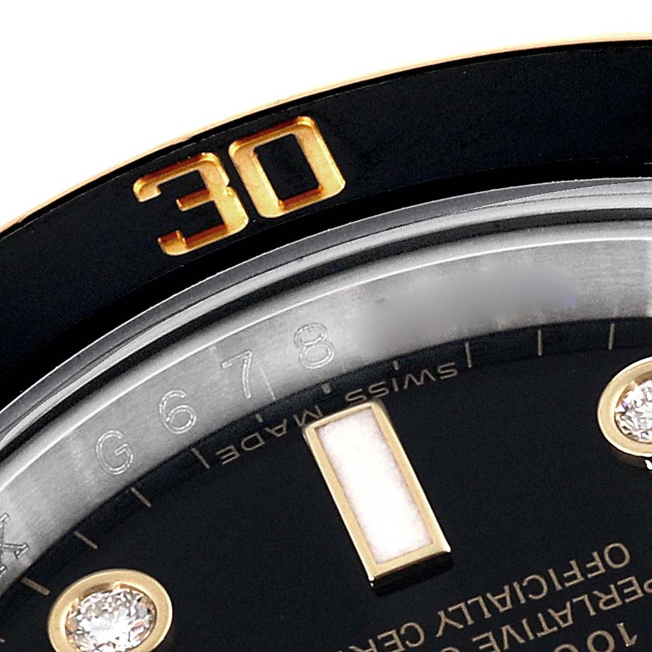 Close-up of the Rolex Submariner 116613 Men's Steel and Gold (two tone) Black Dial 116613 Men's Steel and Gold (two tone) Black Dial watch showing the bezel with the "30" marking, part of the dial, and the indices.