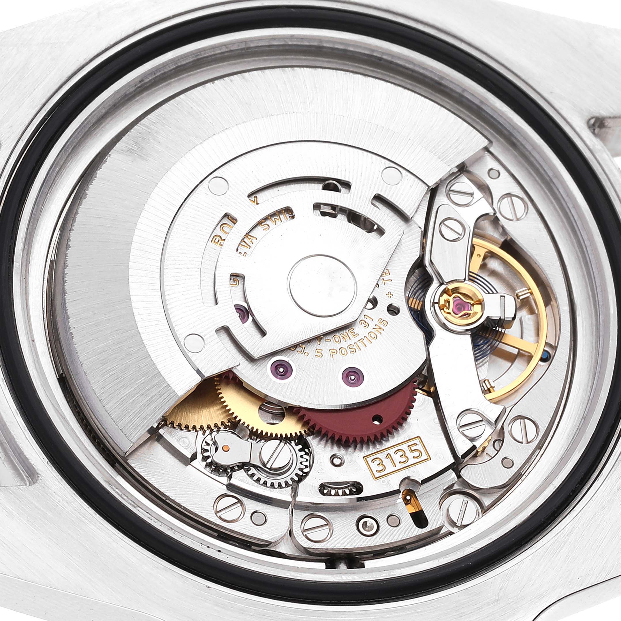 This image shows a close-up of the internal movement of a Rolex Submariner 116613 Men's Steel and Gold (two tone) Black Dial 116613 Men's Steel and Gold (two tone) Black Dial watch, displaying gears, rotors, and other mechanisms.