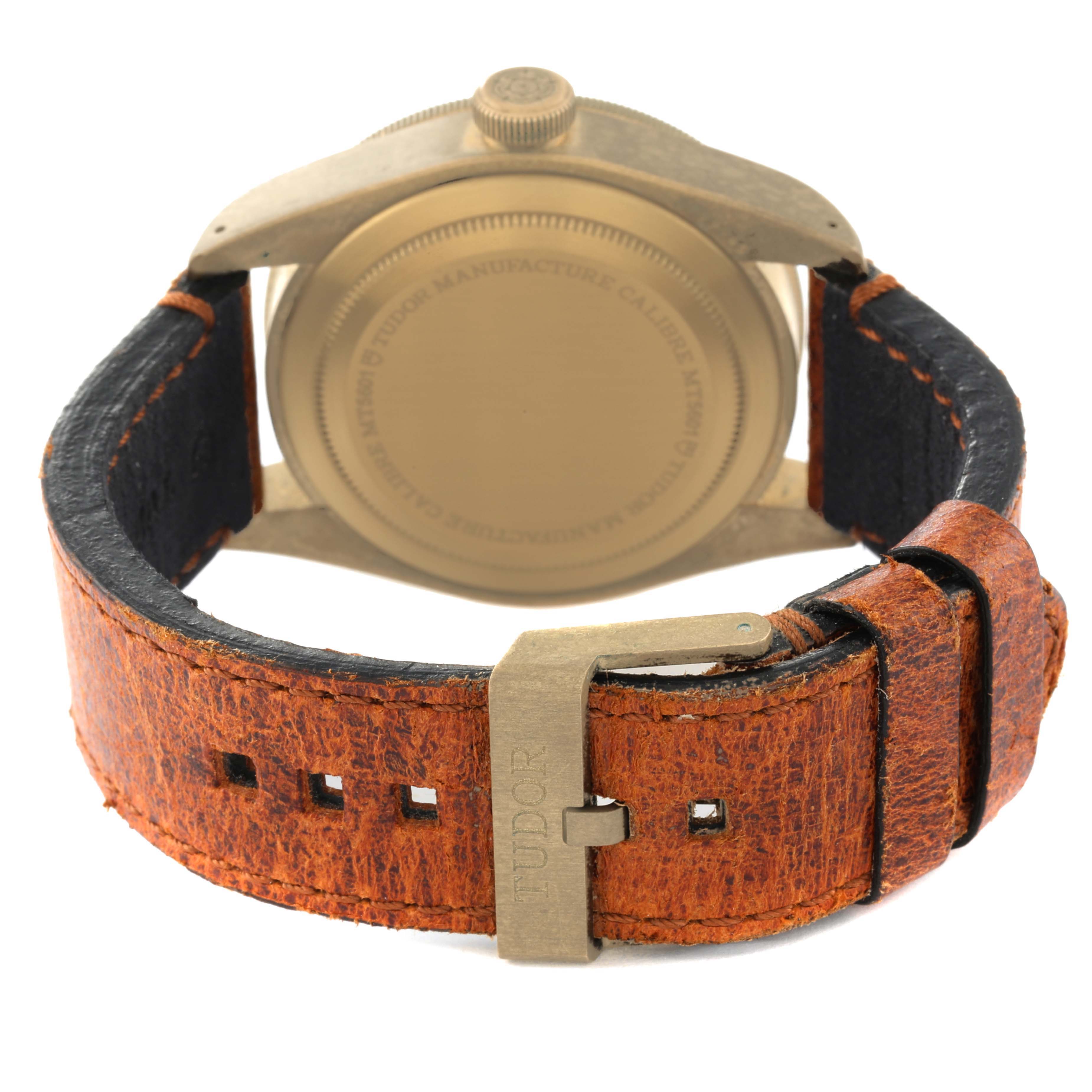 This image shows the back view of a Tudor Heritage Black Bay 79250B Men's Bronze Brown Dial 79250B Men's Bronze Brown Dial watch with a brown leather strap and a visible buckle.