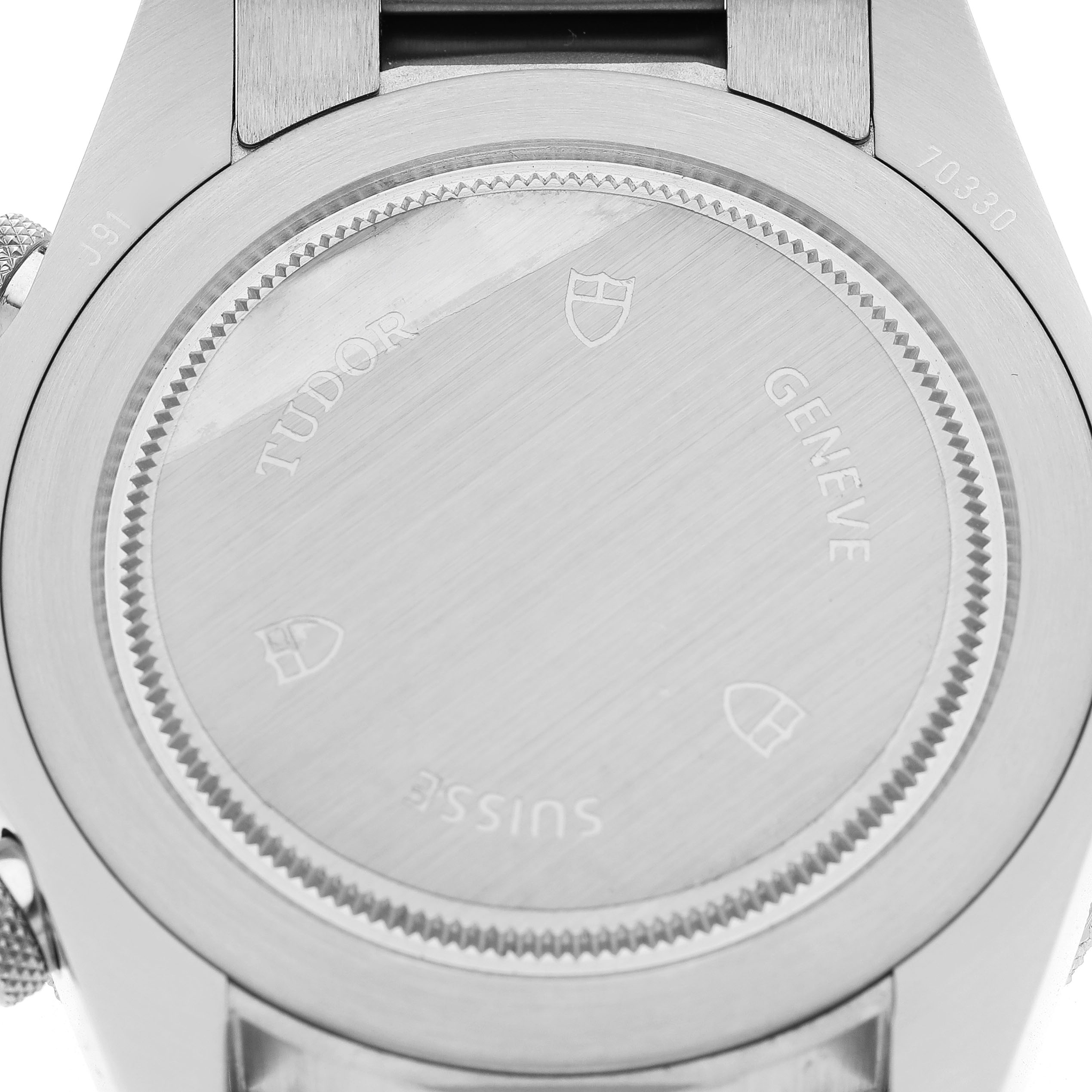 The image shows the back of a Tudor Heritage Chrono 70330N-65740 Men's Stainless Steel Grey Dial watch, highlighting the engraved caseback details.