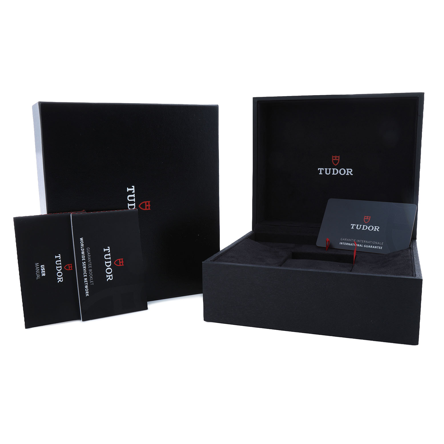 The image shows the packaging and accessories for the Tudor Heritage Chrono 70330N-65740 Men's Stainless Steel Grey Dial, including a box, manuals, and a warranty card.