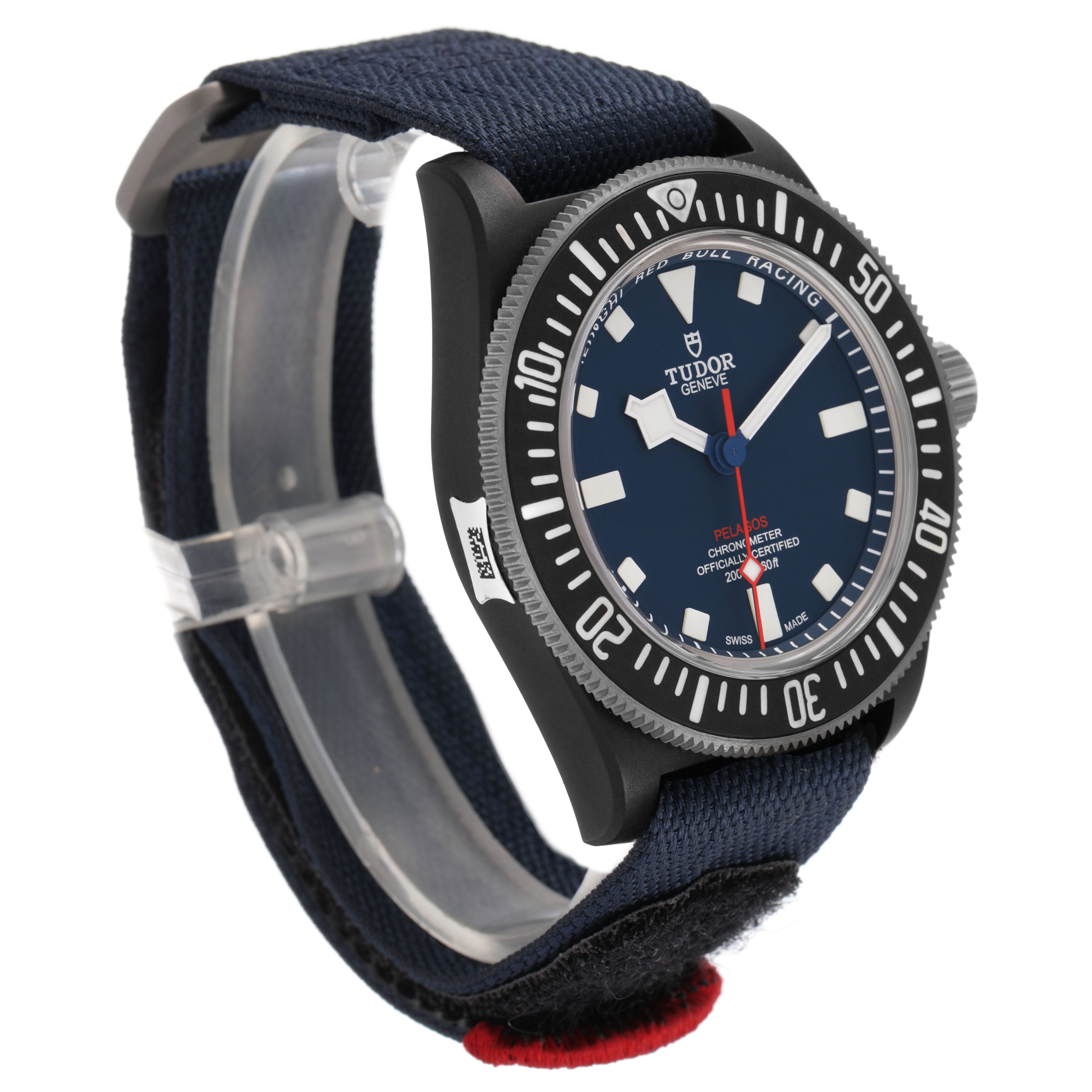 The Tudor Pelagos 25707KN Men's Titanium Blue Dial watch is shown at a three-quarter angle, highlighting its dial, bezel, and fabric strap.