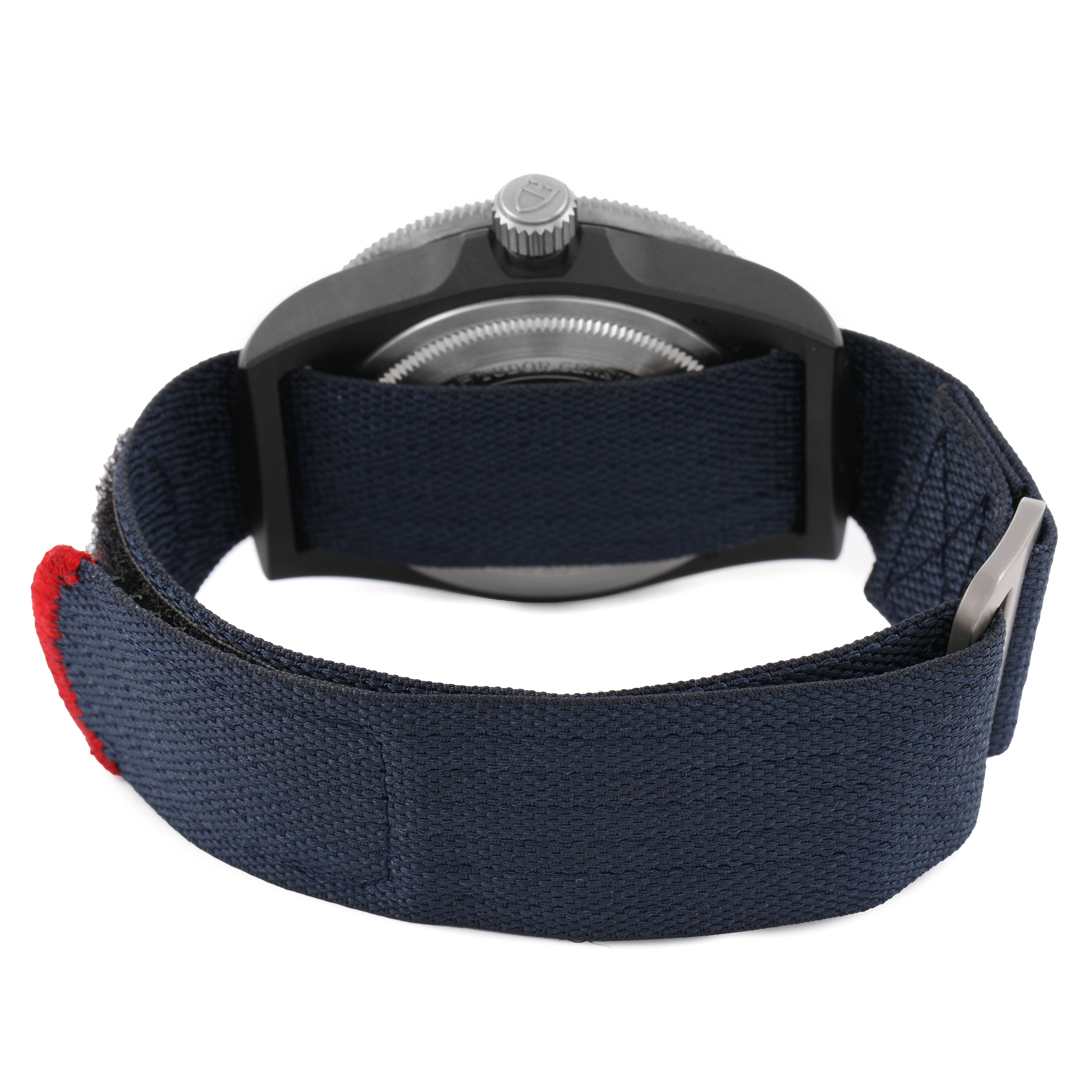 The image shows the Tudor Pelagos 25707KN Men's Titanium Blue Dial watch from the backside, highlighting the crown and fabric strap with a buckle.