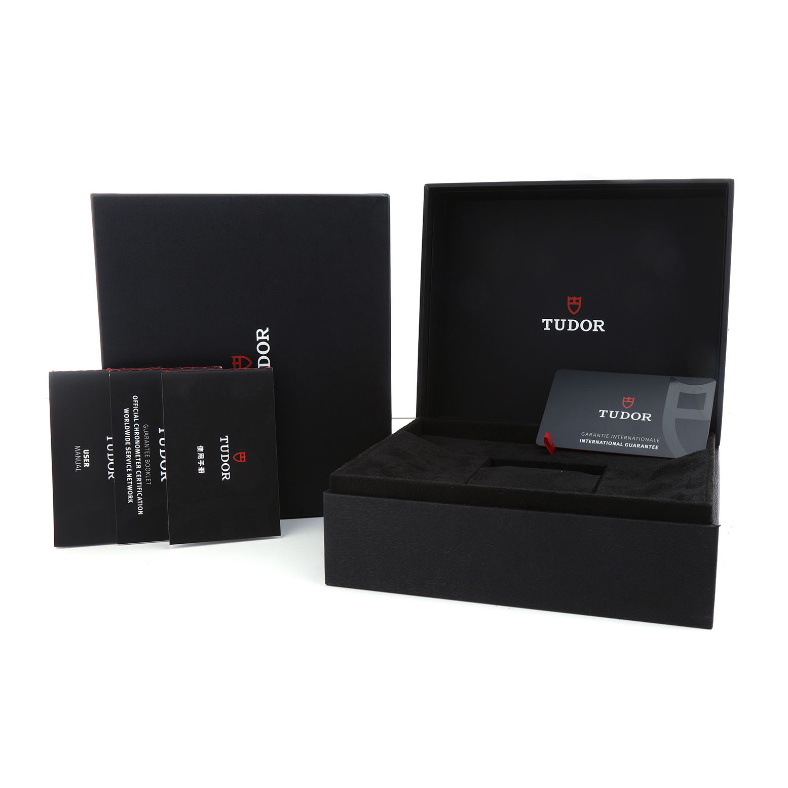 The image shows the packaging and accessories of a Tudor Pelagos 25707KN Men's Titanium Blue Dial watch, including an open box, warranty card, and manuals.
