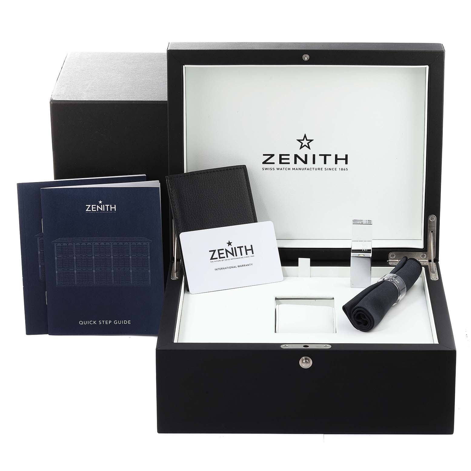 The image shows the open box of a Zenith Chronomaster 03.3100.3600 Men's Stainless Steel Black Dial 03.3100.3600 Men's Stainless Steel Black Dial watch, displaying the user guides, warranty card, and accessories.