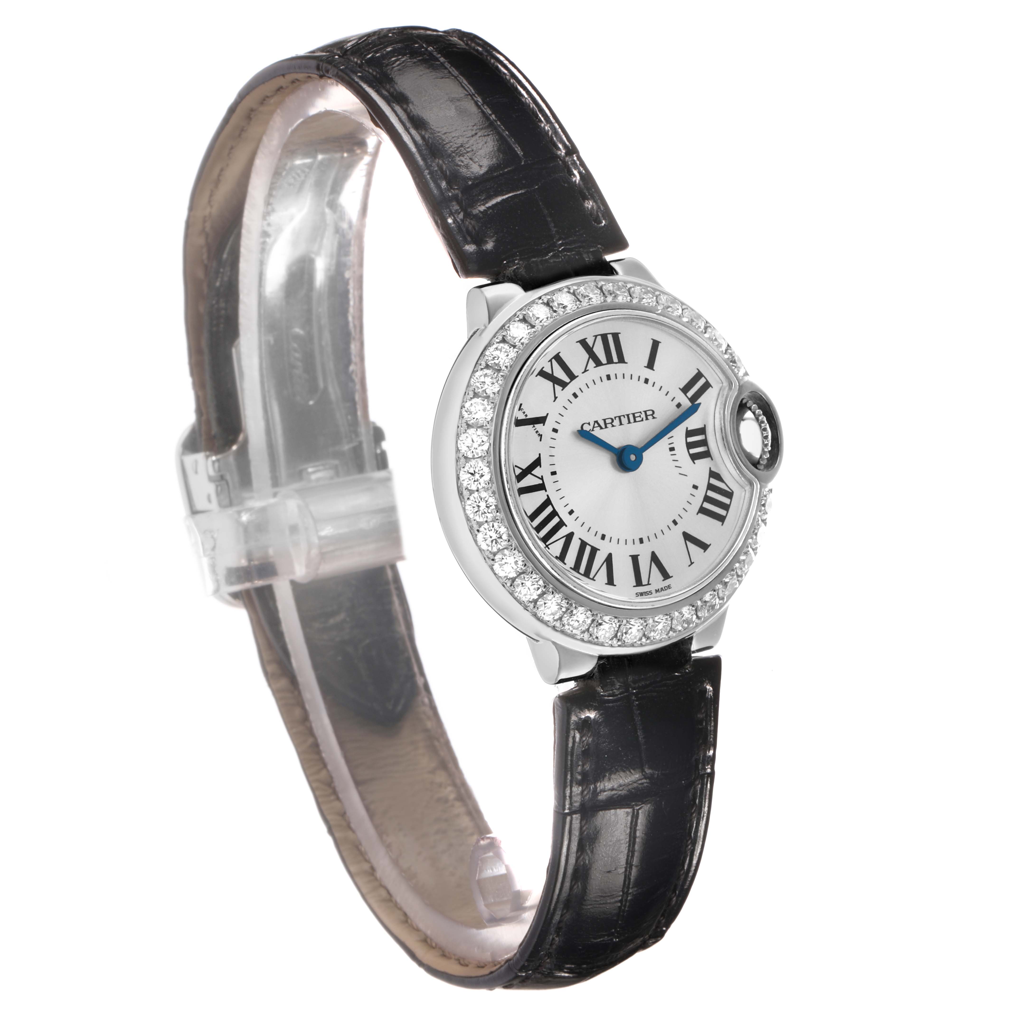 The Cartier Ballon Bleu WE900351 Women's White Gold Silver Dial watch is shown at a slight vertical angle, highlighting the face, diamond bezel, and leather strap.