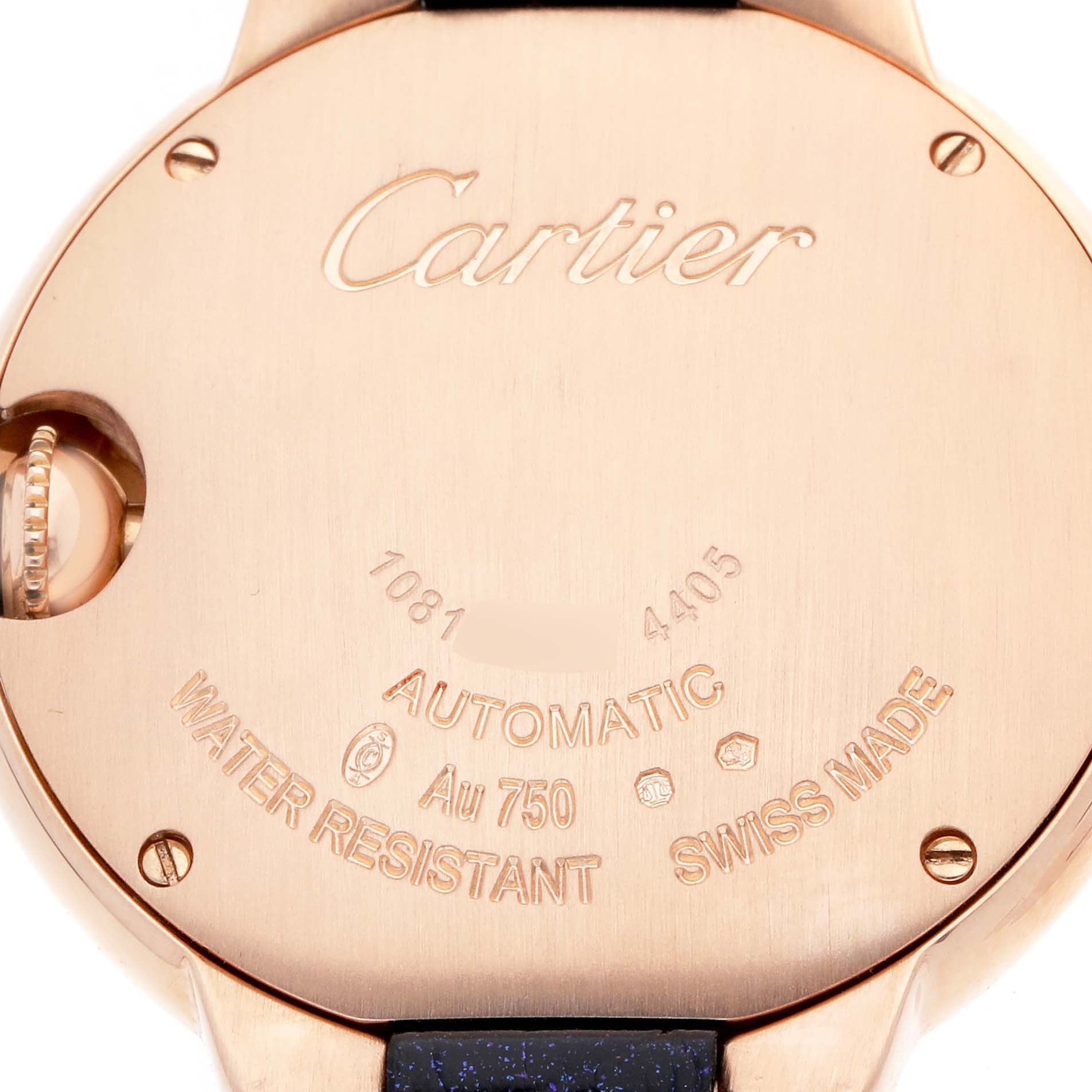The image shows the back case of a Cartier Ballon Bleu WGBB0052 Women's Rose Gold Silver Dial watch, displaying engravings and the crown partially visible.