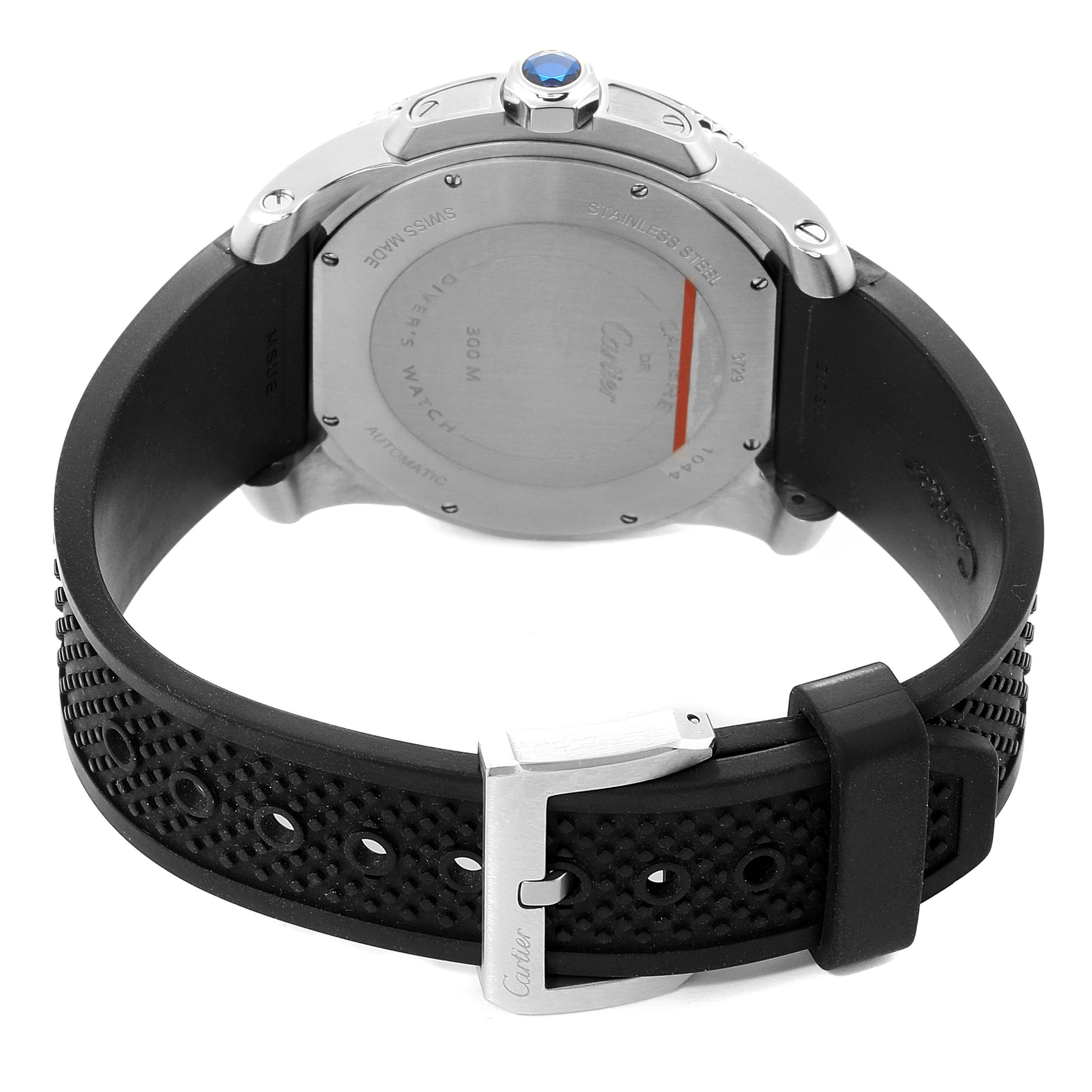The image shows the back view of the Calibre de Cartier watch by Cartier, featuring its case back, crown, and black rubber strap with a buckle.