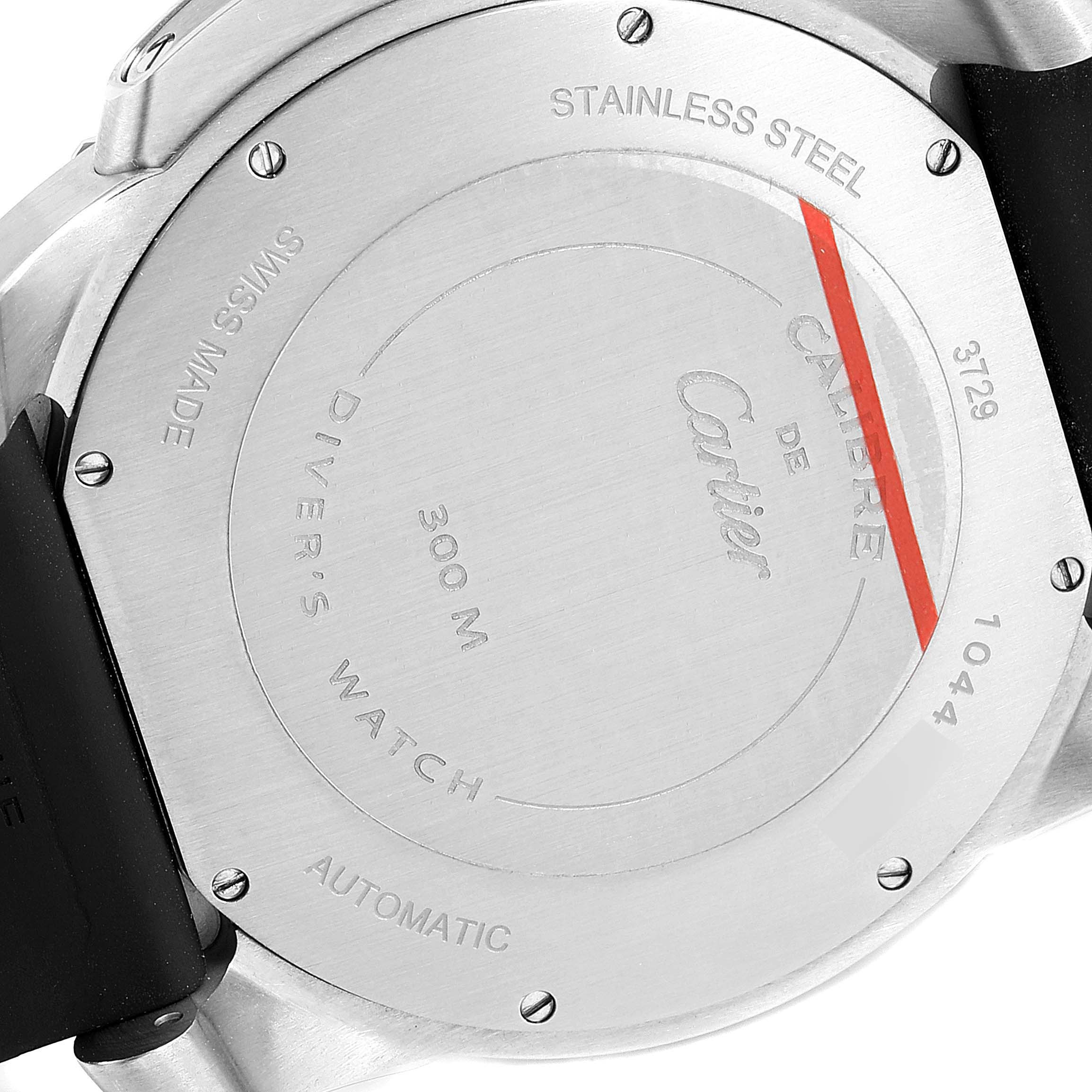 The image shows the back side and case of a Calibre de Cartier watch by Cartier, highlighting the stainless steel and automatic engravings.