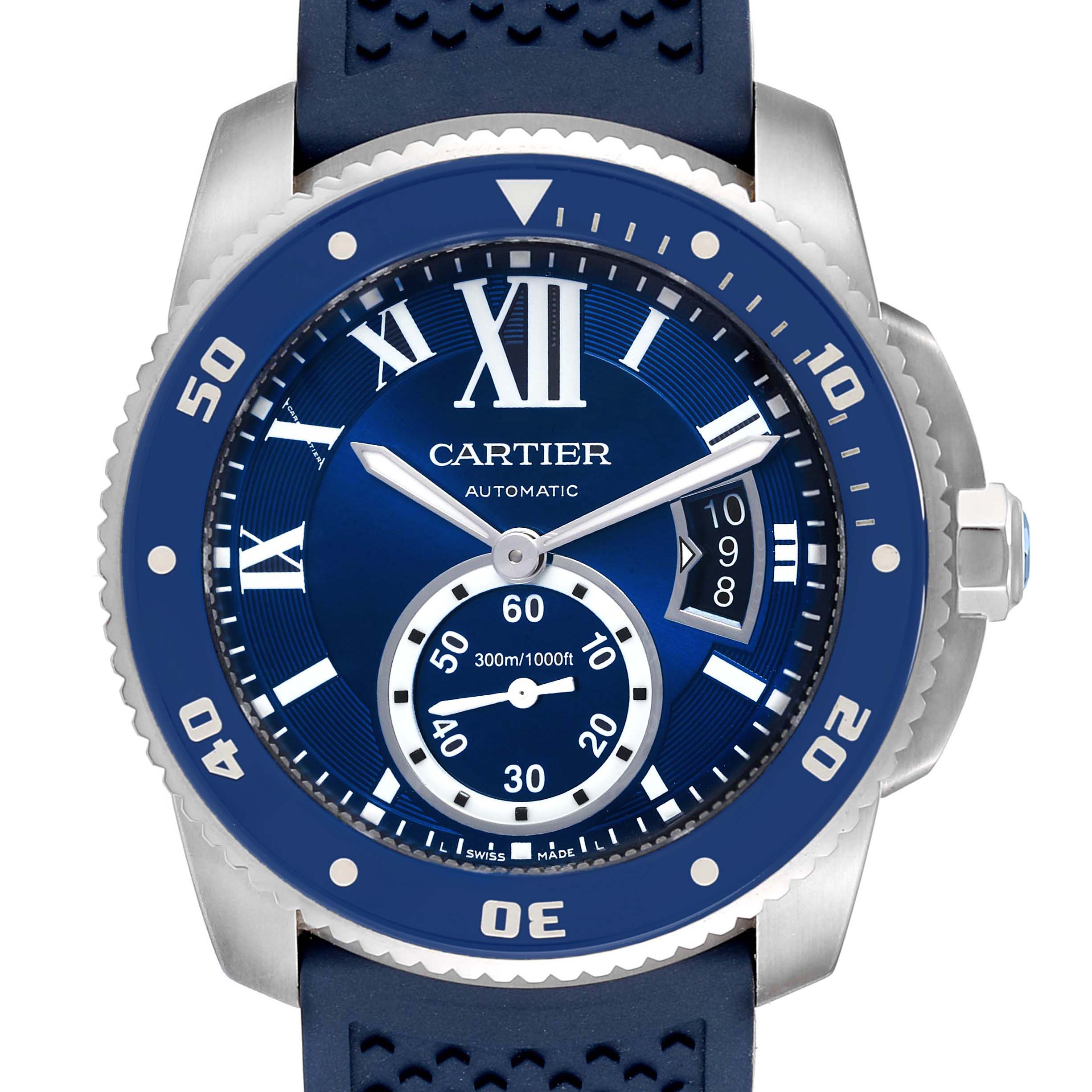 The image shows a close-up, front view of a Calibre de Cartier watch by Cartier, highlighting its blue dial and bezel.