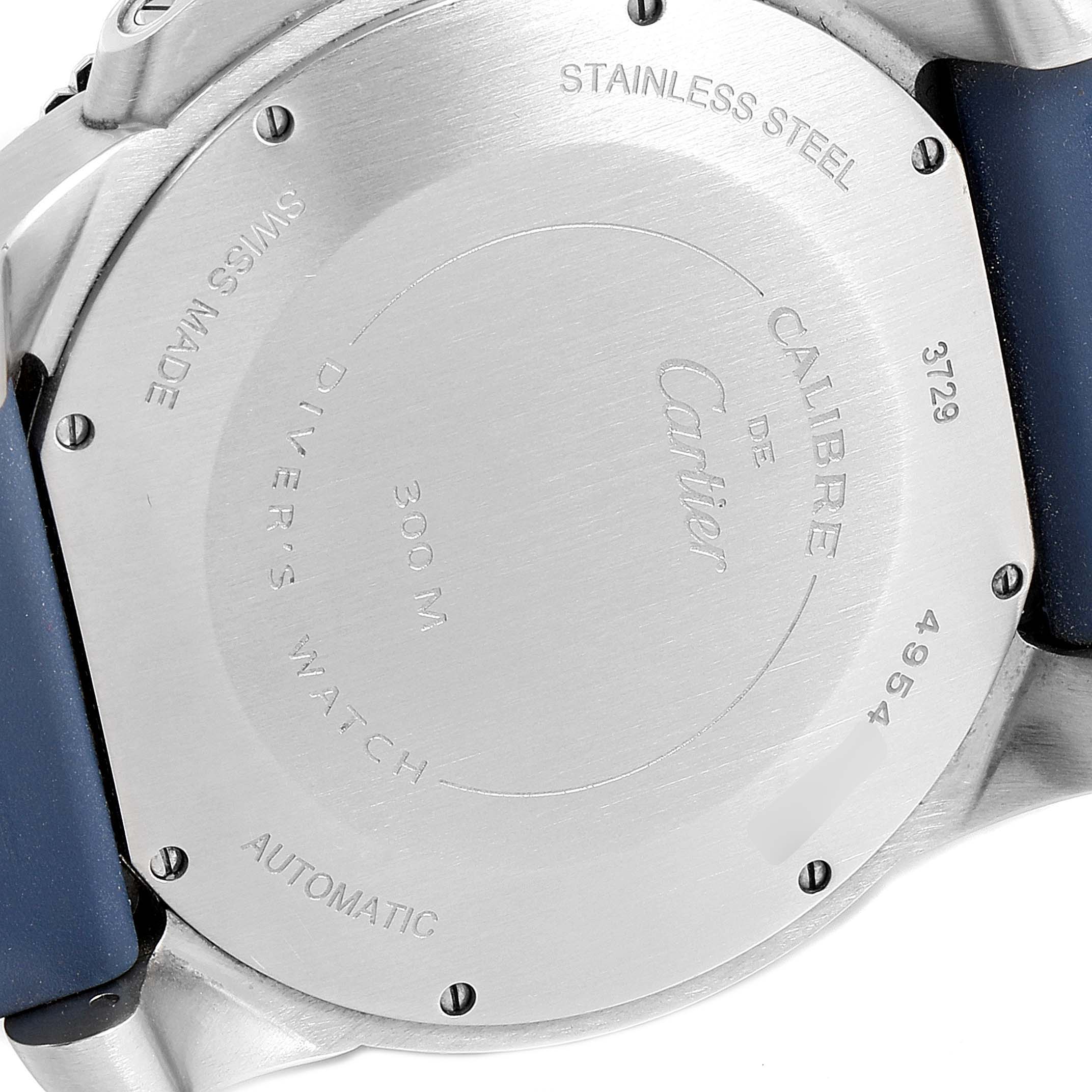 The image shows the back case of the Calibre de Cartier watch by Cartier at an angle, highlighting its engravings and strap attachment.