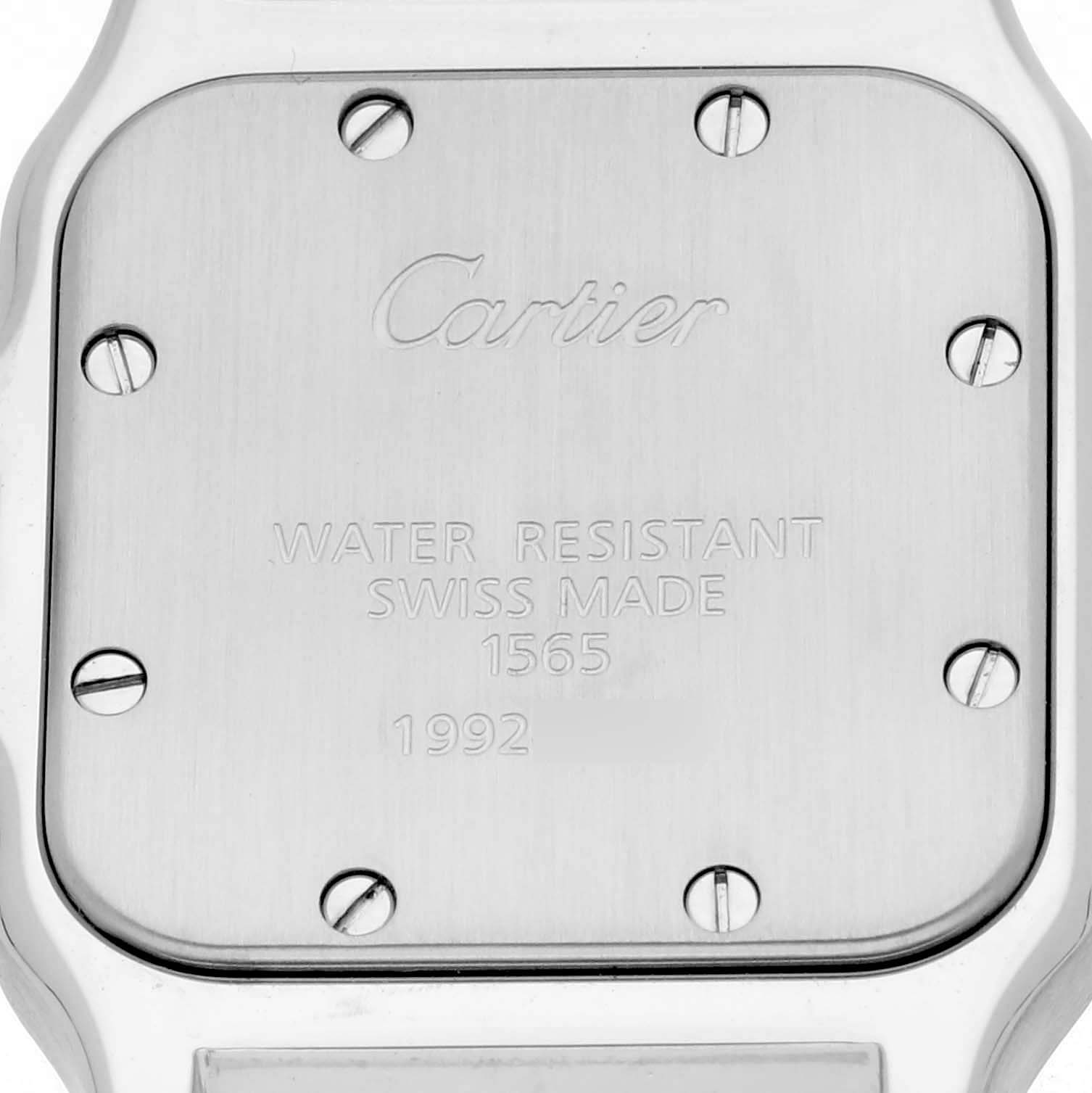 The image shows the back case of a Cartier Santos W20056D6 Women's Stainless Steel Silver Dial W20056D6 Women's Stainless Steel Silver Dial watch, featuring engravings and screws.