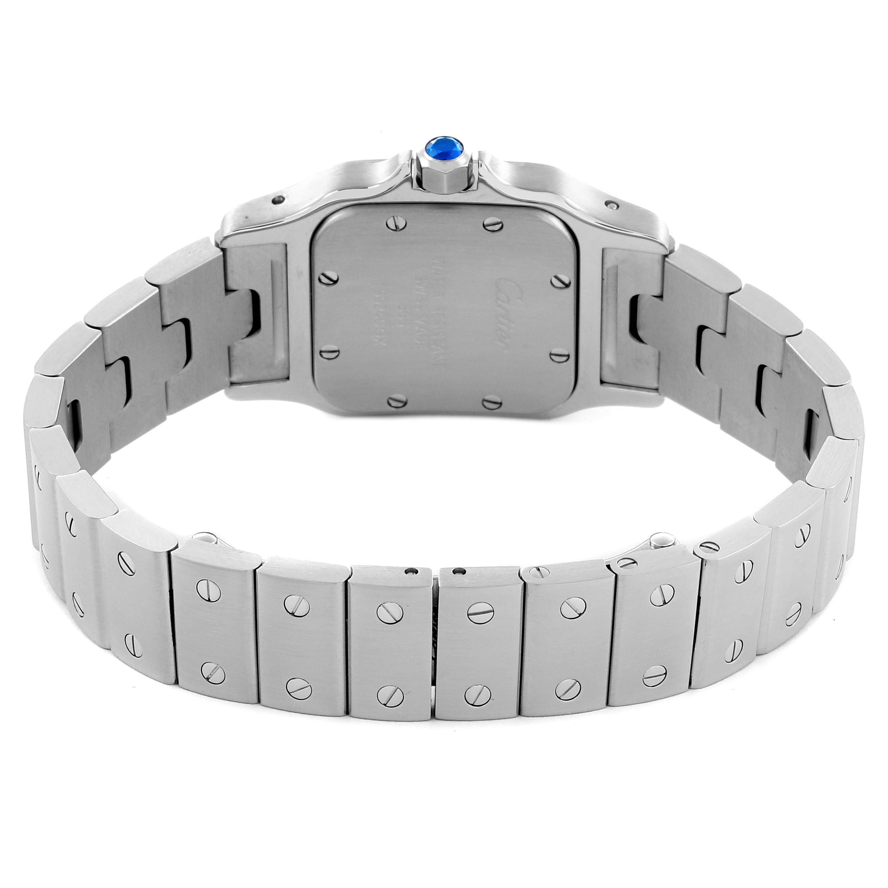 The image shows the back case and bracelet of a Cartier Santos W20056D6 Women's Stainless Steel Silver Dial W20056D6 Women's Stainless Steel Silver Dial watch, highlighting the screw details and crown with a blue gem.