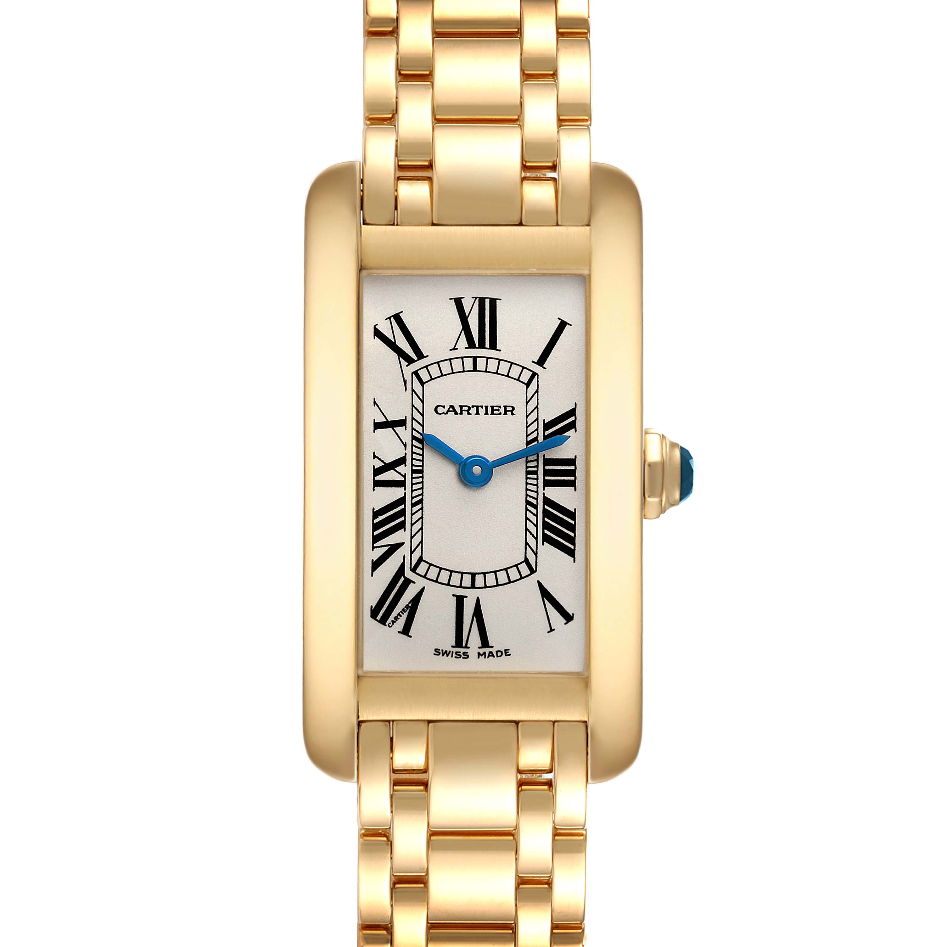 The image shows a front view of the Cartier Tank Americaine W26015K2 Women
s Yellow Gold Silver Dial W26015K2 Women
s Yellow Gold Silver Dial watch, highlighting its gold case, Roman numerals, and blue hands.