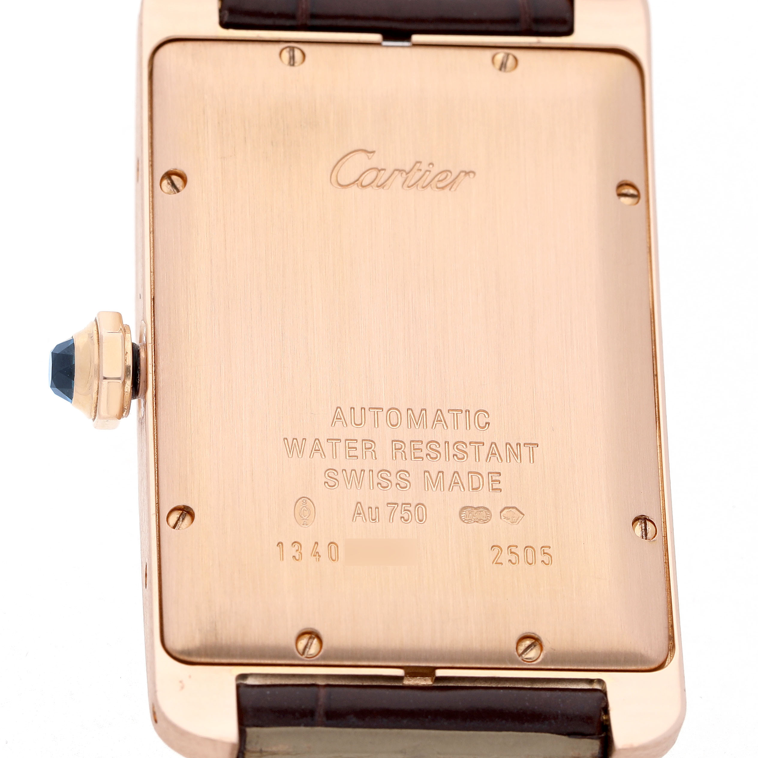 The image shows the back of the Cartier Tank Americaine W2609156 Men's Rose Gold Silver Dial watch, highlighting engravings and the crown with a blue stone.