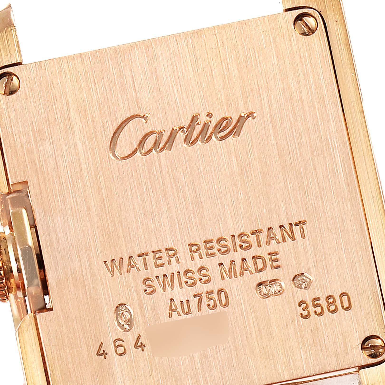 This image shows the back casing of a Cartier Tank Anglaise WT100024 Women's Rose Gold Silver Dial WT100024 Women's Rose Gold Silver Dial watch with inscriptions indicating water resistance, Swiss made, and other details.