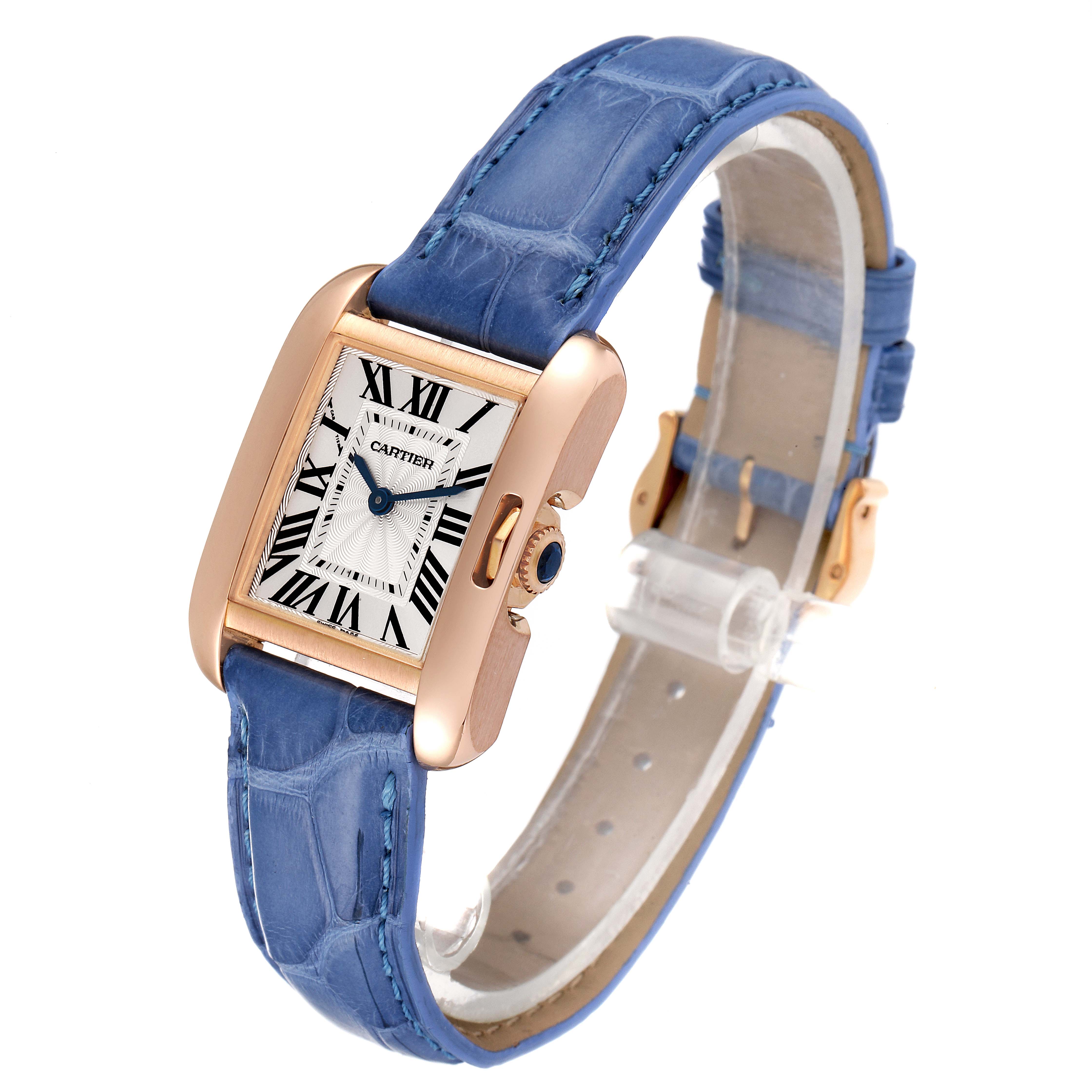 The Cartier Tank Anglaise WT100024 Women's Rose Gold Silver Dial WT100024 Women's Rose Gold Silver Dial watch is shown from a 3/4 angle, highlighting its rectangular dial and blue leather strap.