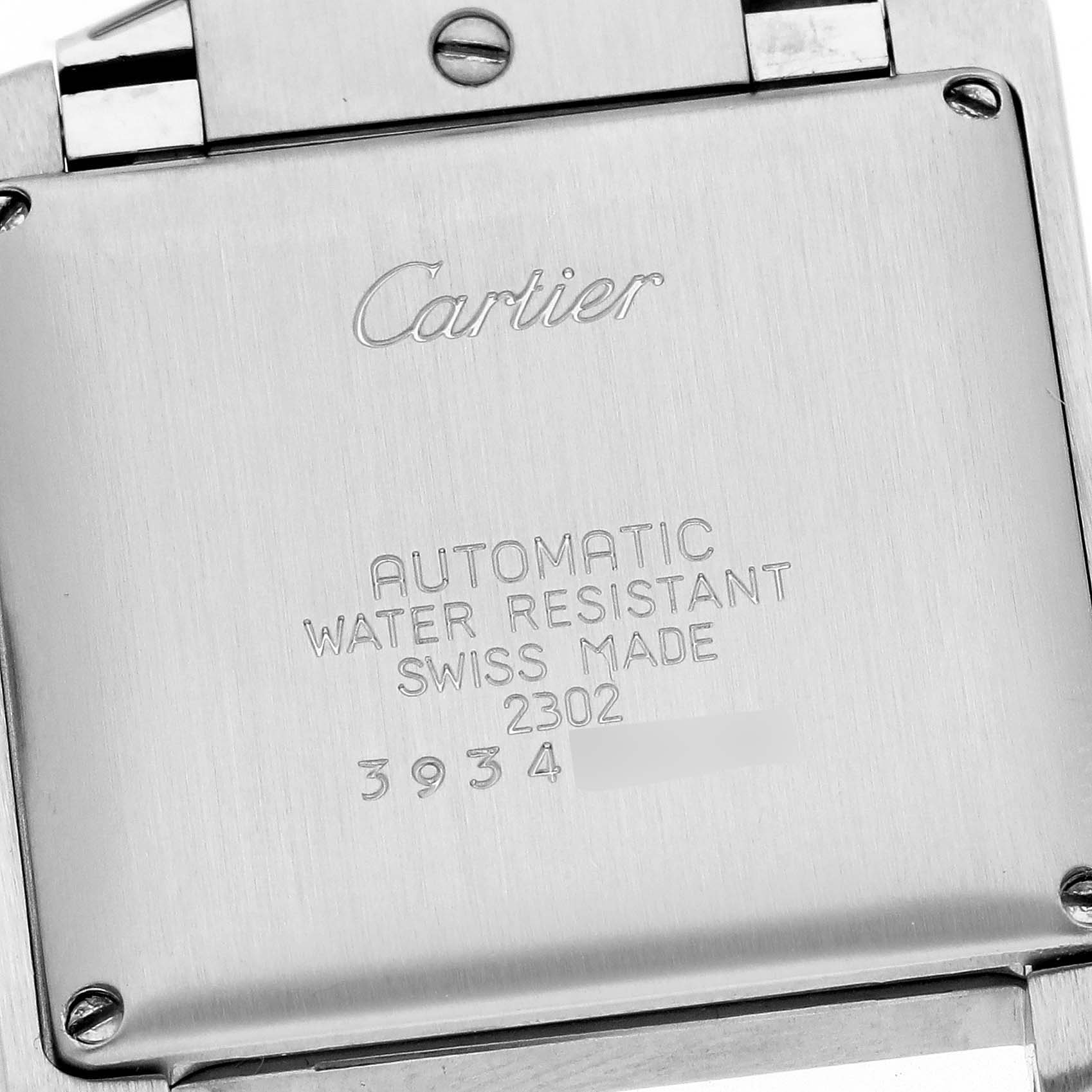 The image shows the case back of the Cartier Tank Française, displaying engravings and screws.