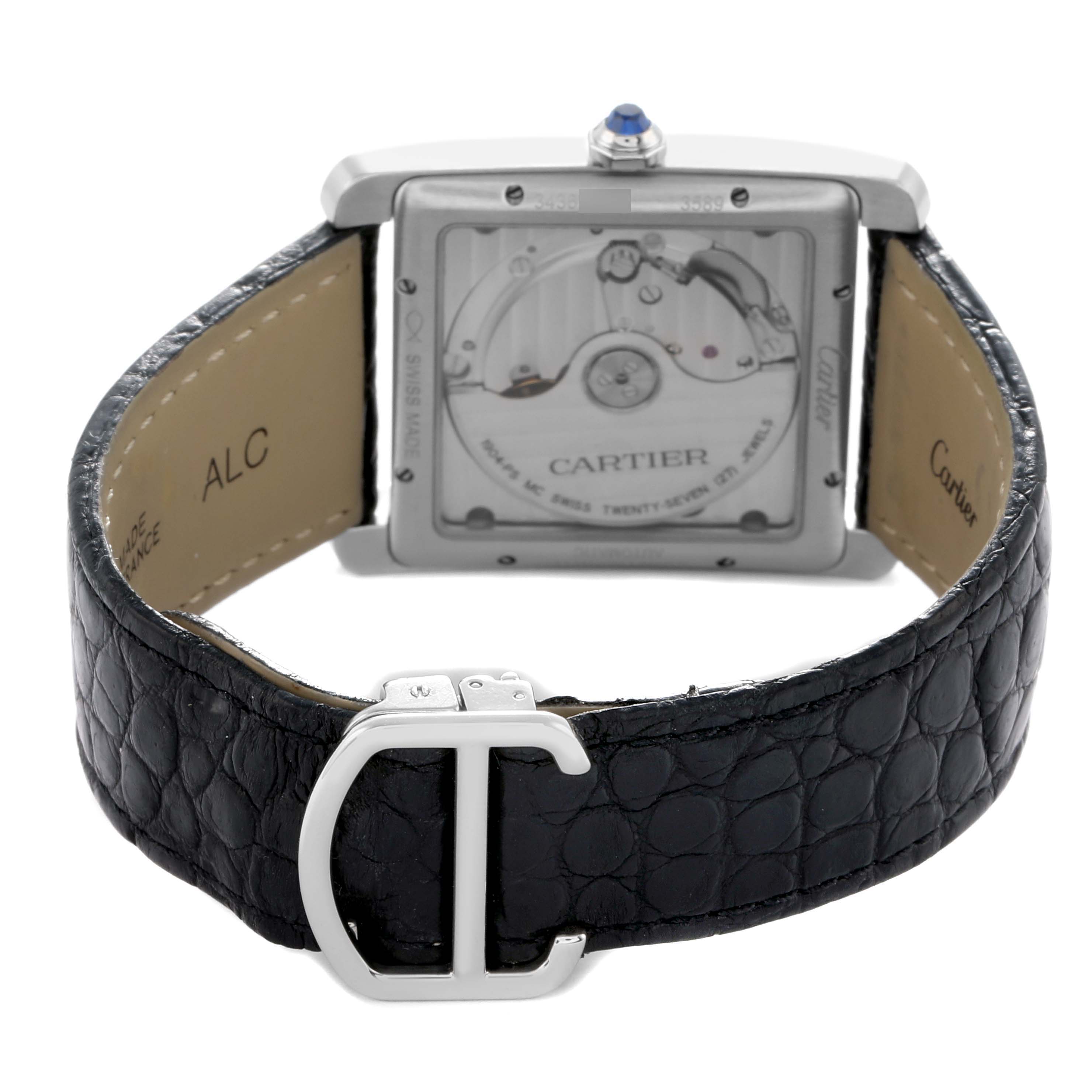 The Cartier Tank MC W5330003 Men
s Stainless Steel Silver Dial watch is shown from the back, displaying the movement through a transparent case and a leather strap with a buckle.