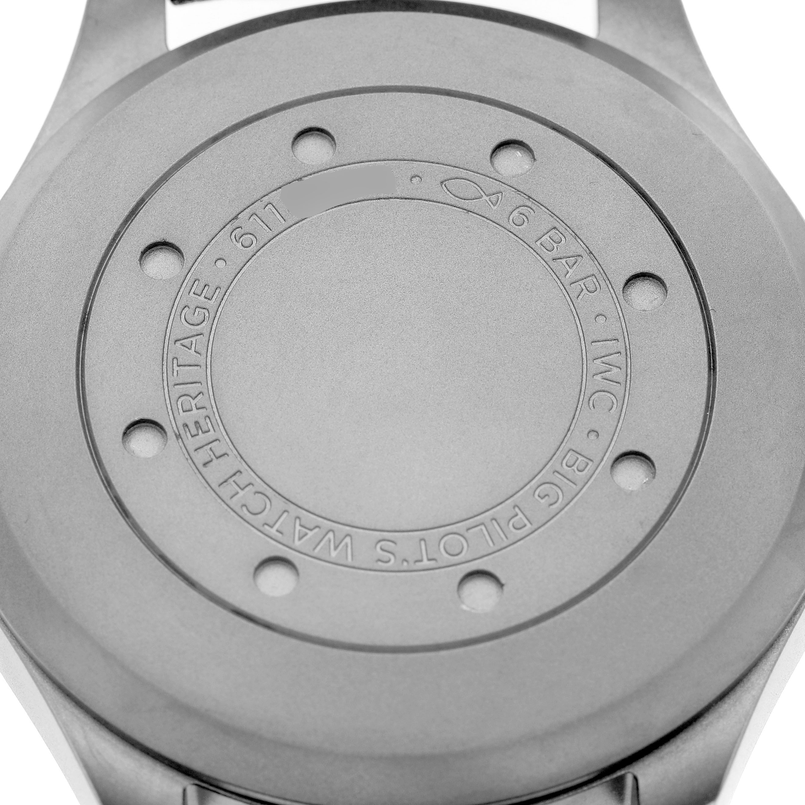 The image shows the back case of the IWC Pilot IW510301 Men's Titanium Black Dial model watch, highlighting the engraved details and design.
