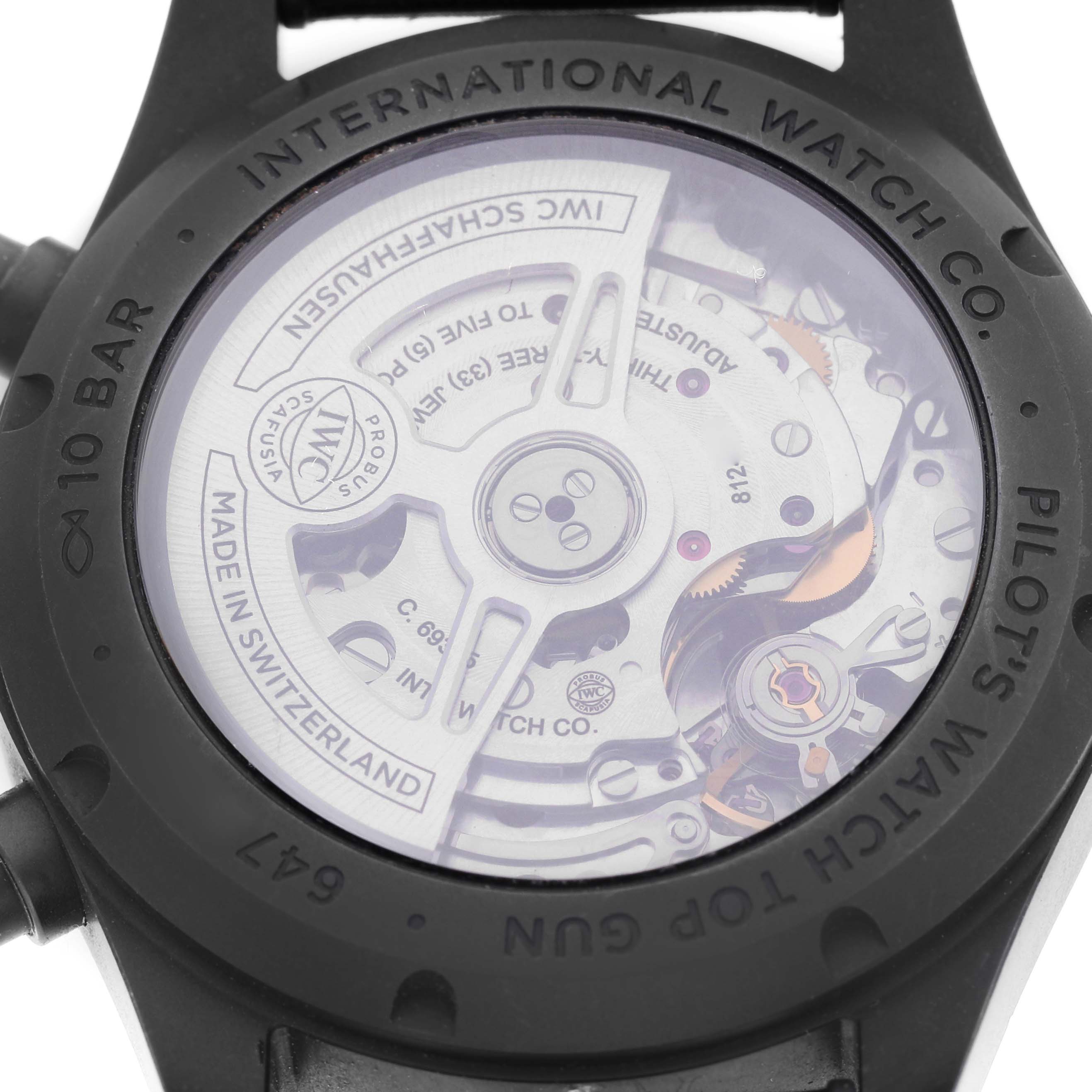 The image shows the case back of an IWC Pilot IW388106 Men's Ceramic Black Dial watch, featuring its visible automatic movement and engraved details.