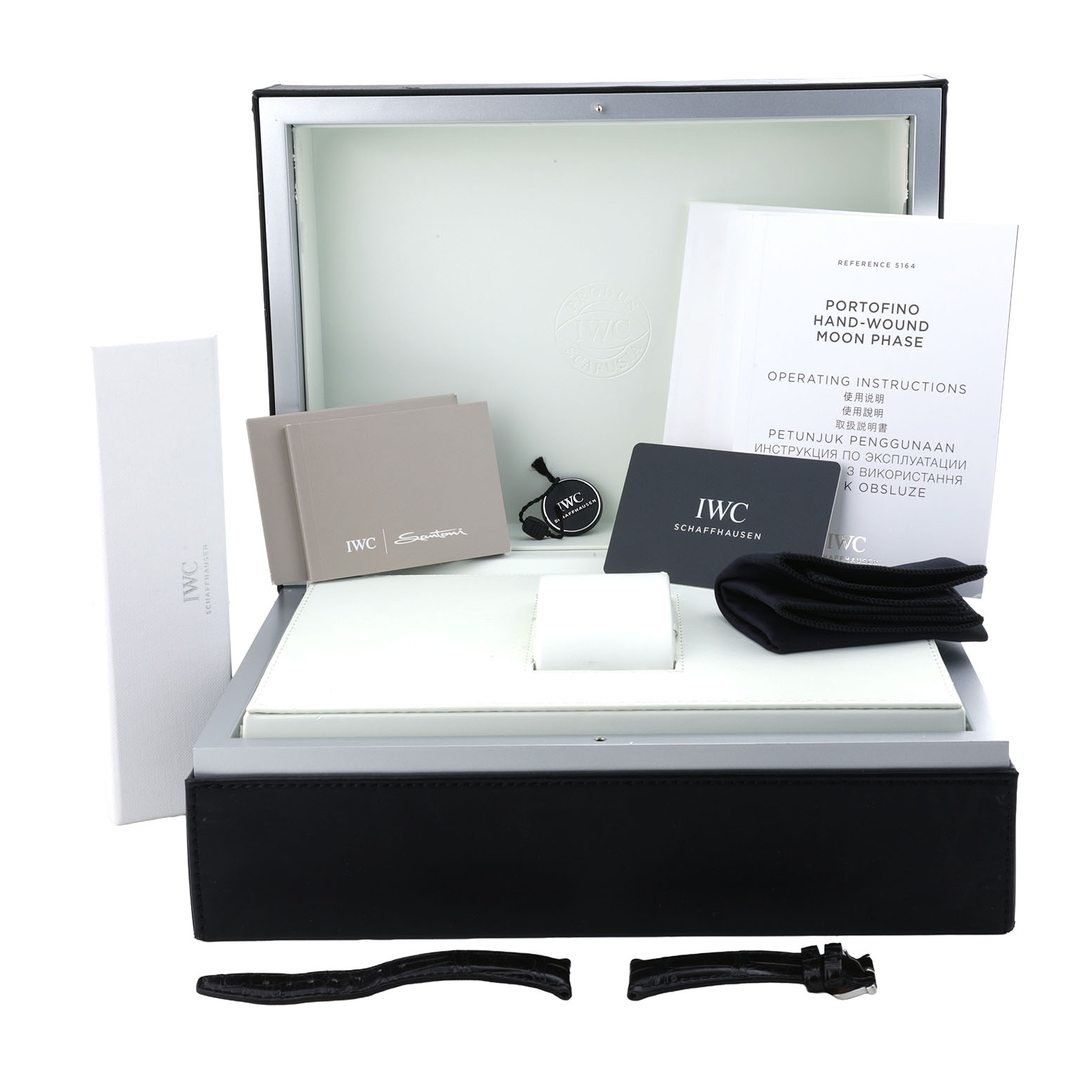 The image shows the packaging and accessories for the IWC Portofino IW516406 Men's Stainless Steel White Dial model, including manuals, extra strap, and a box.