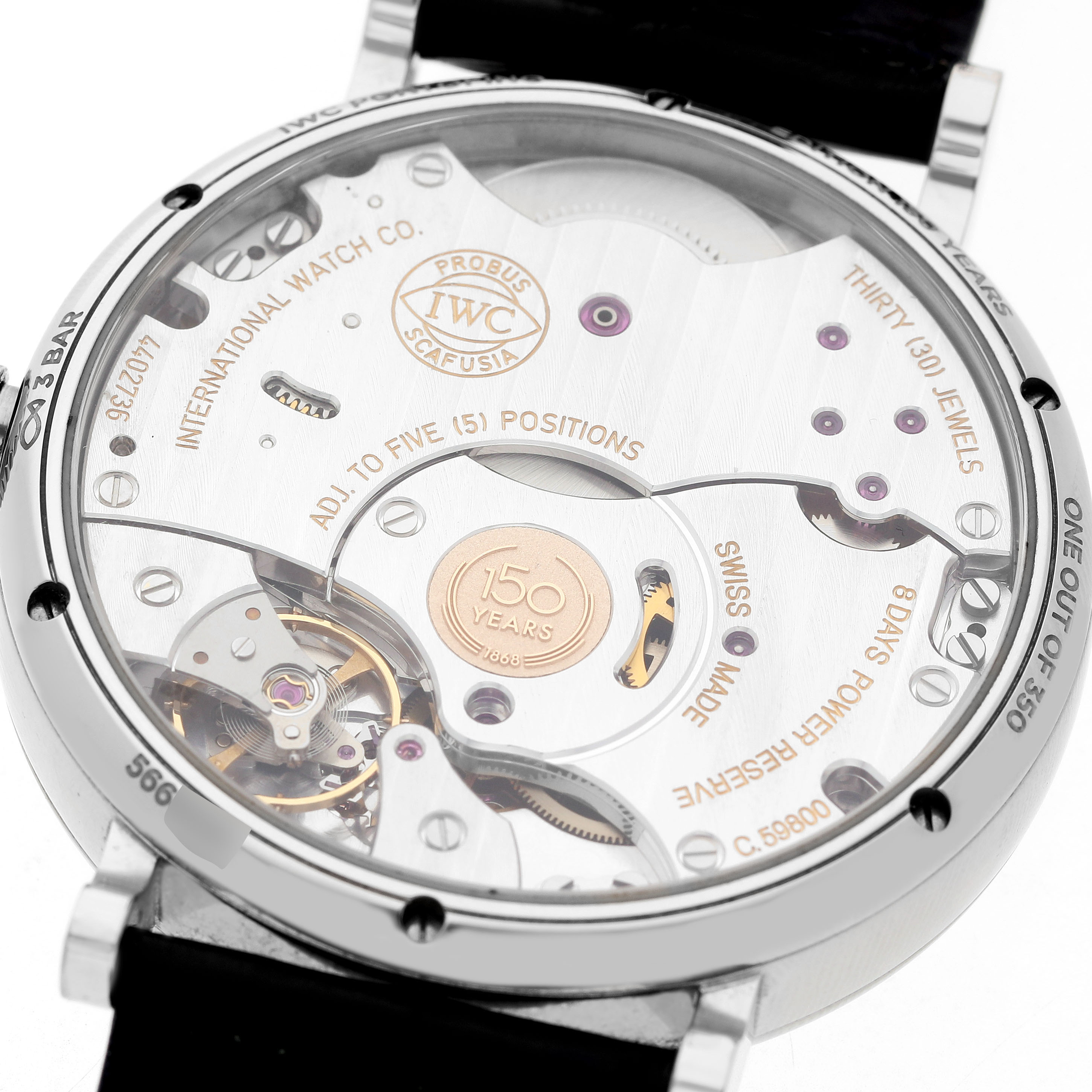 The image shows the back of an IWC Portofino IW516406 Men's Stainless Steel White Dial watch, displaying its mechanical movement and engravings.